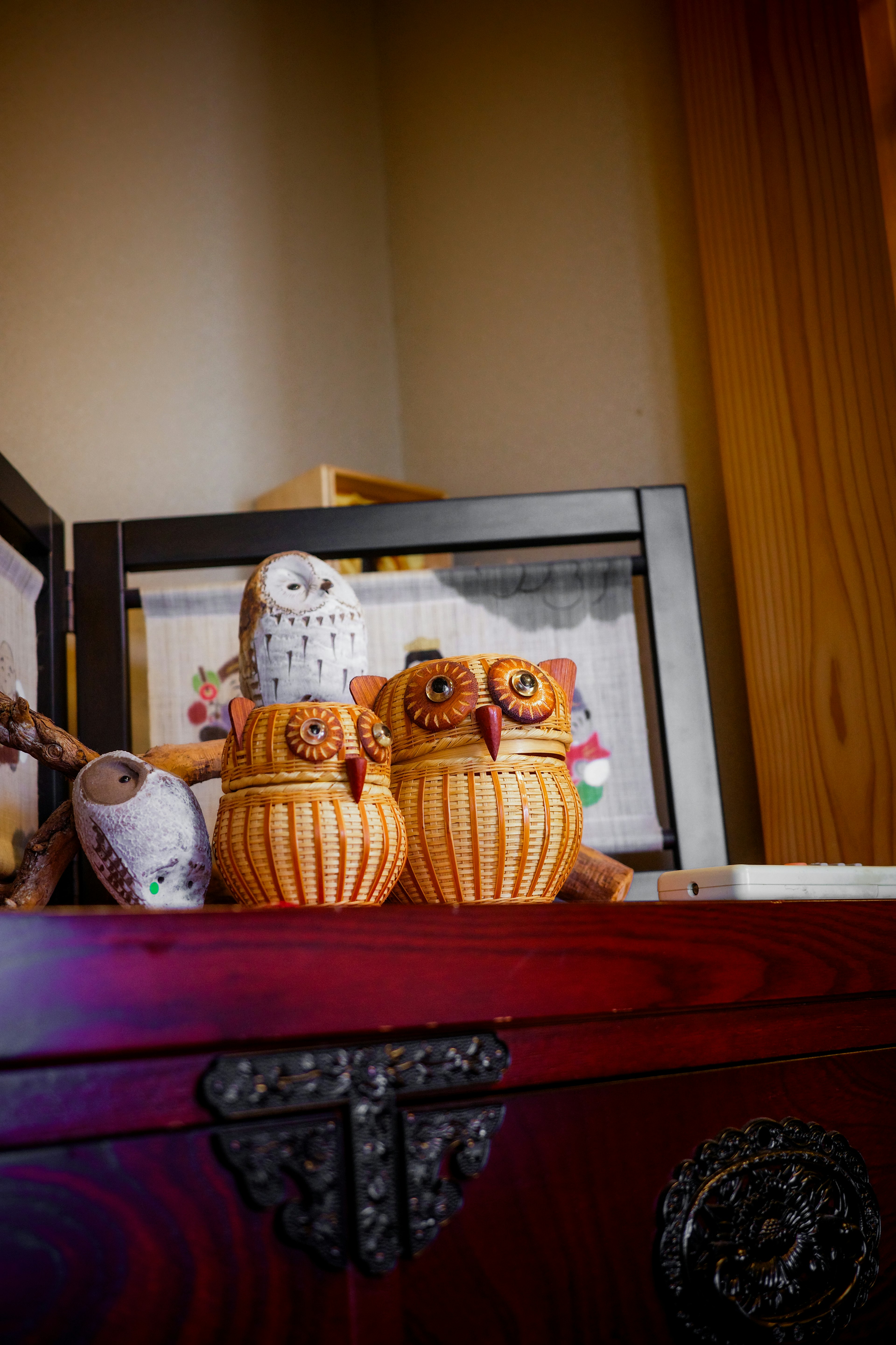 Decorative wooden owl figurines displayed on a shelf