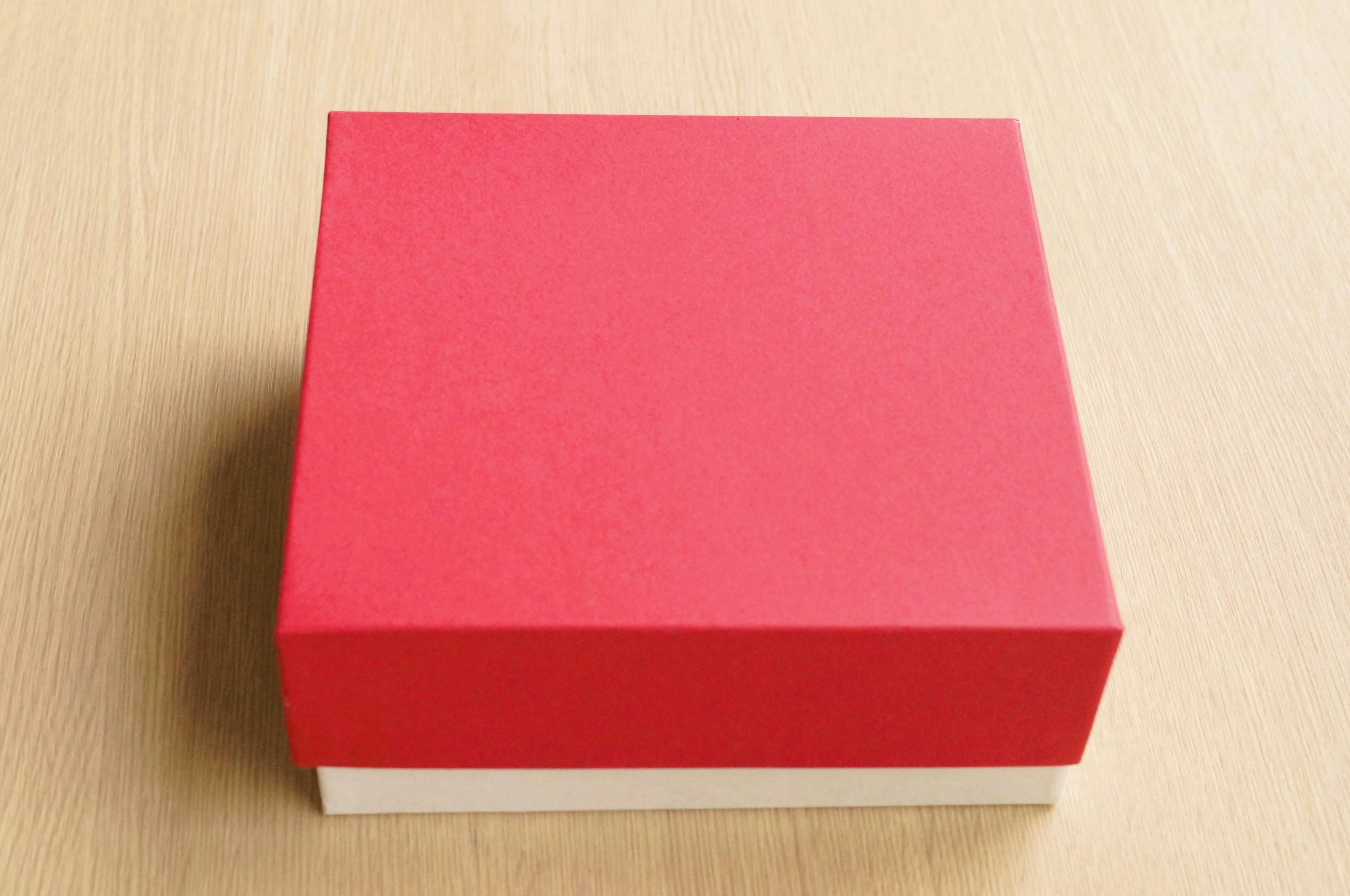 Red box placed on a wooden table