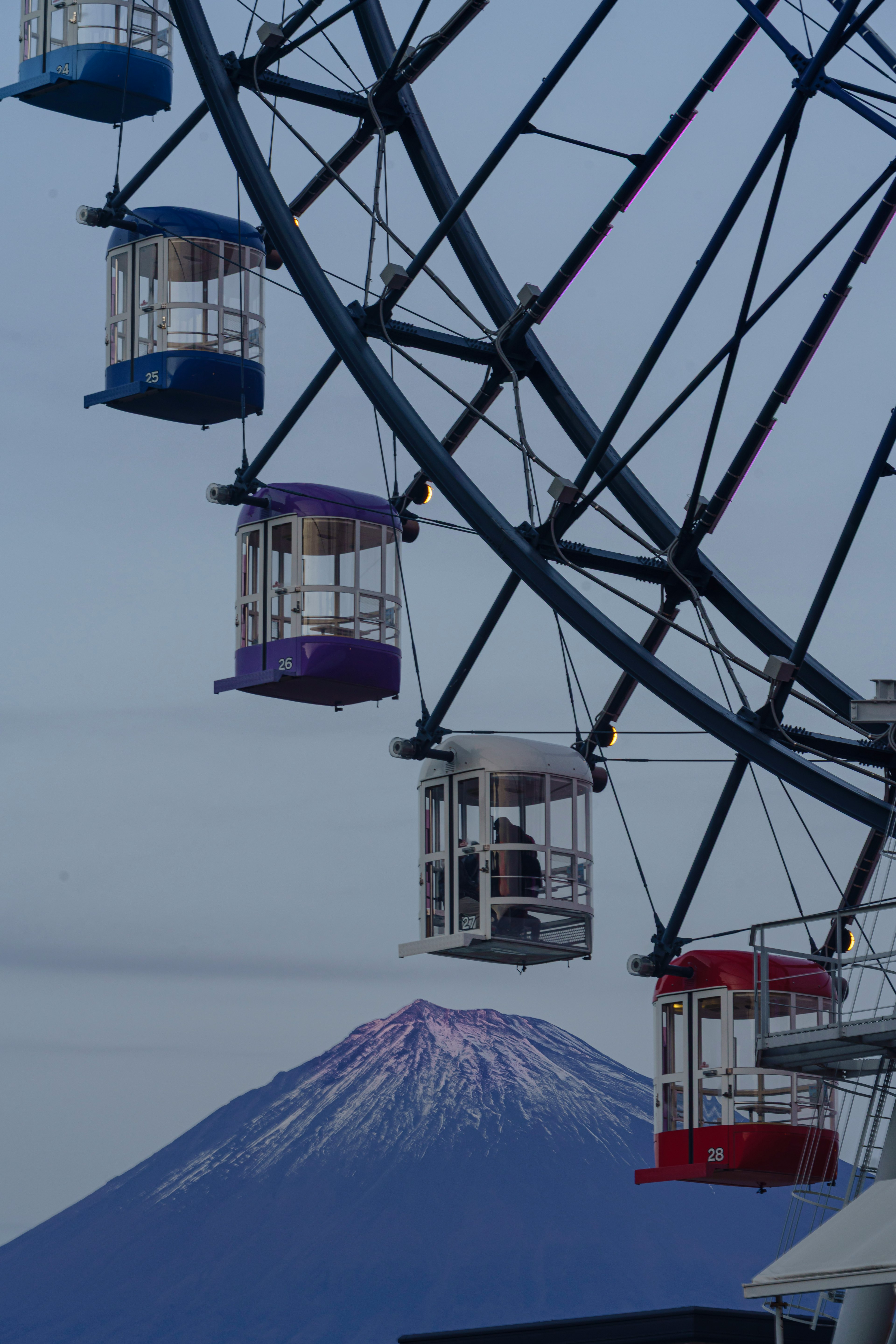 観覧車と富士山の風景 青い空に浮かぶ観覧車のゴンドラと雪をかぶった富士山