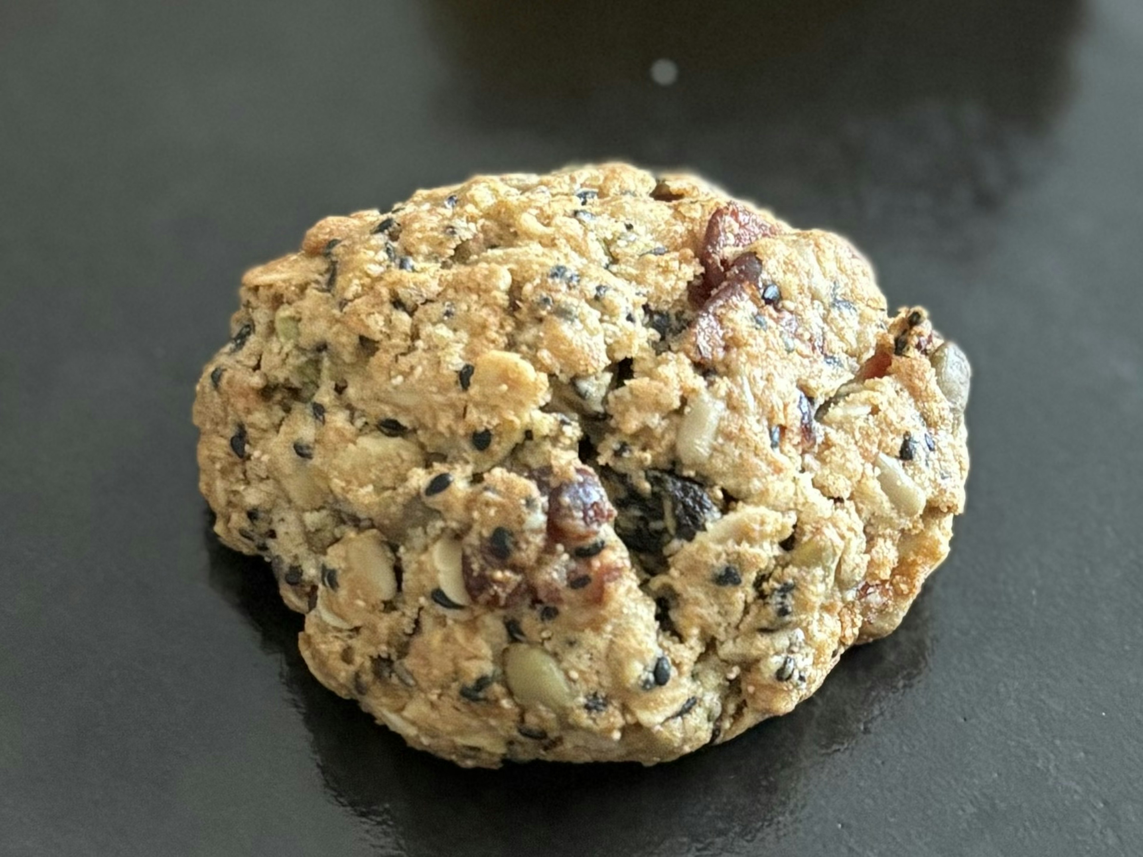 Close-up of a cookie containing black sesame and oats