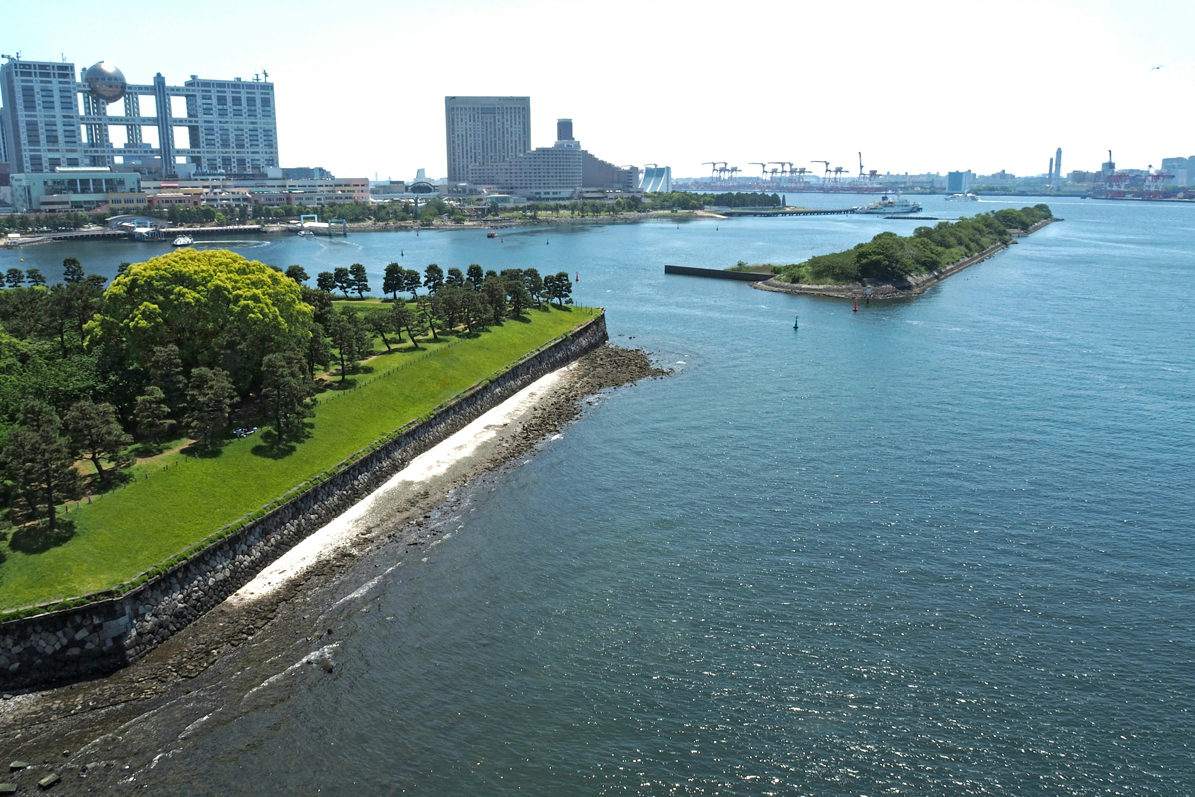 Scenic view of a waterfront park with city skyline