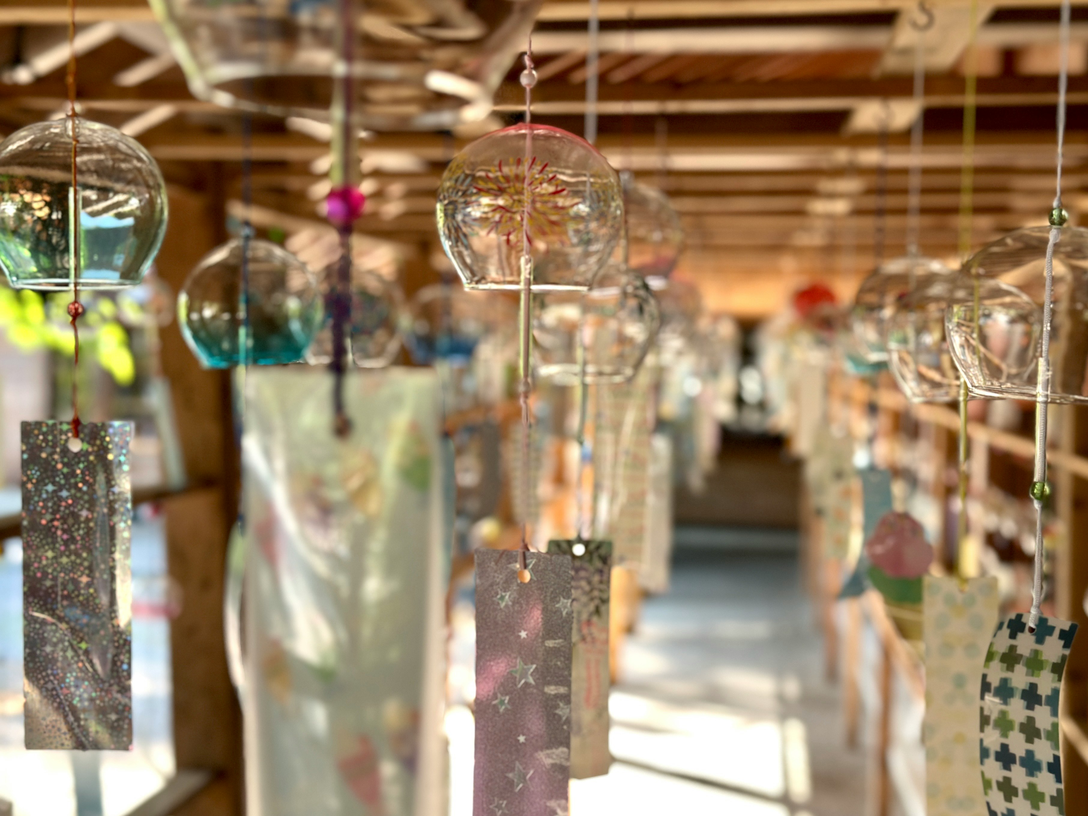 A traditional Japanese space with transparent wind chimes hanging variously designed strips swaying