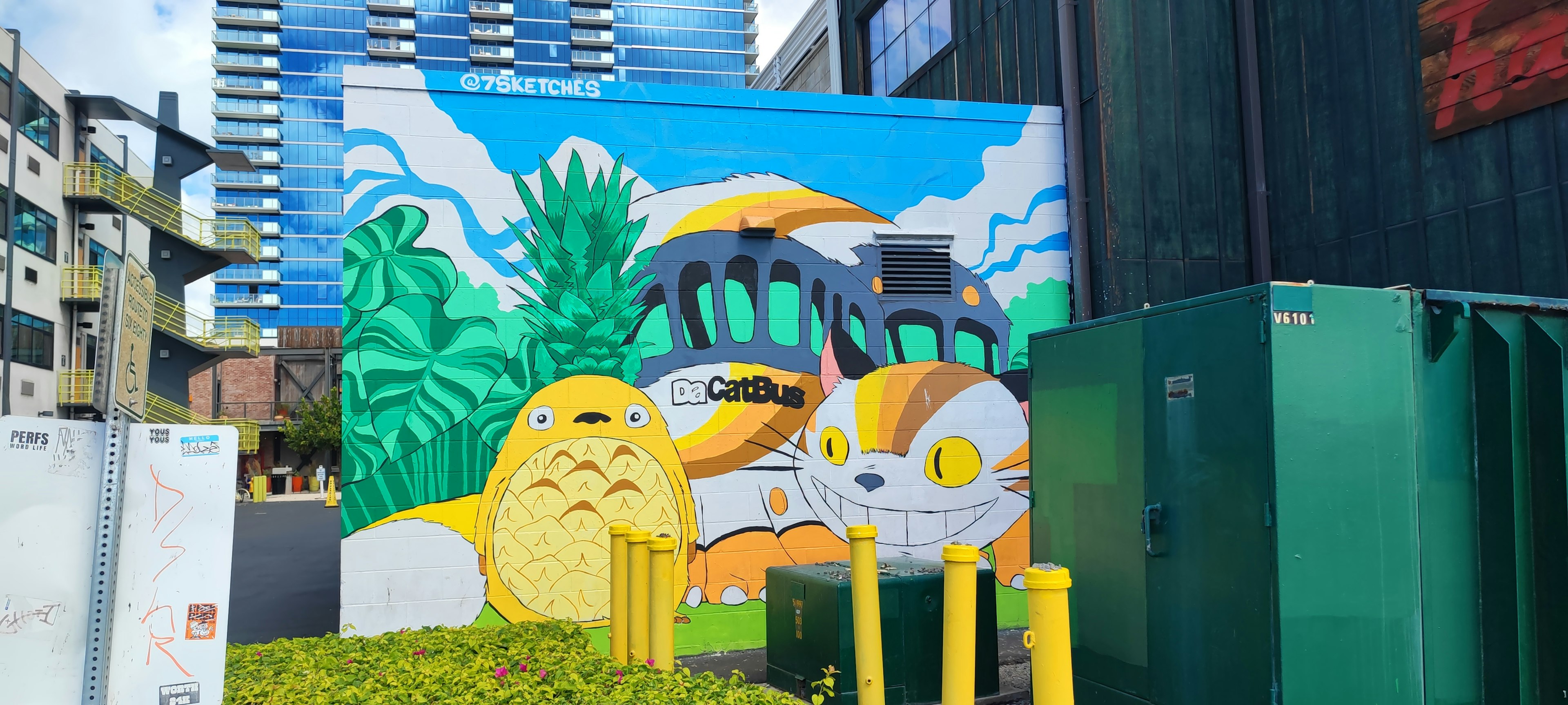 Colorful mural featuring cartoon cats and vibrant landscape