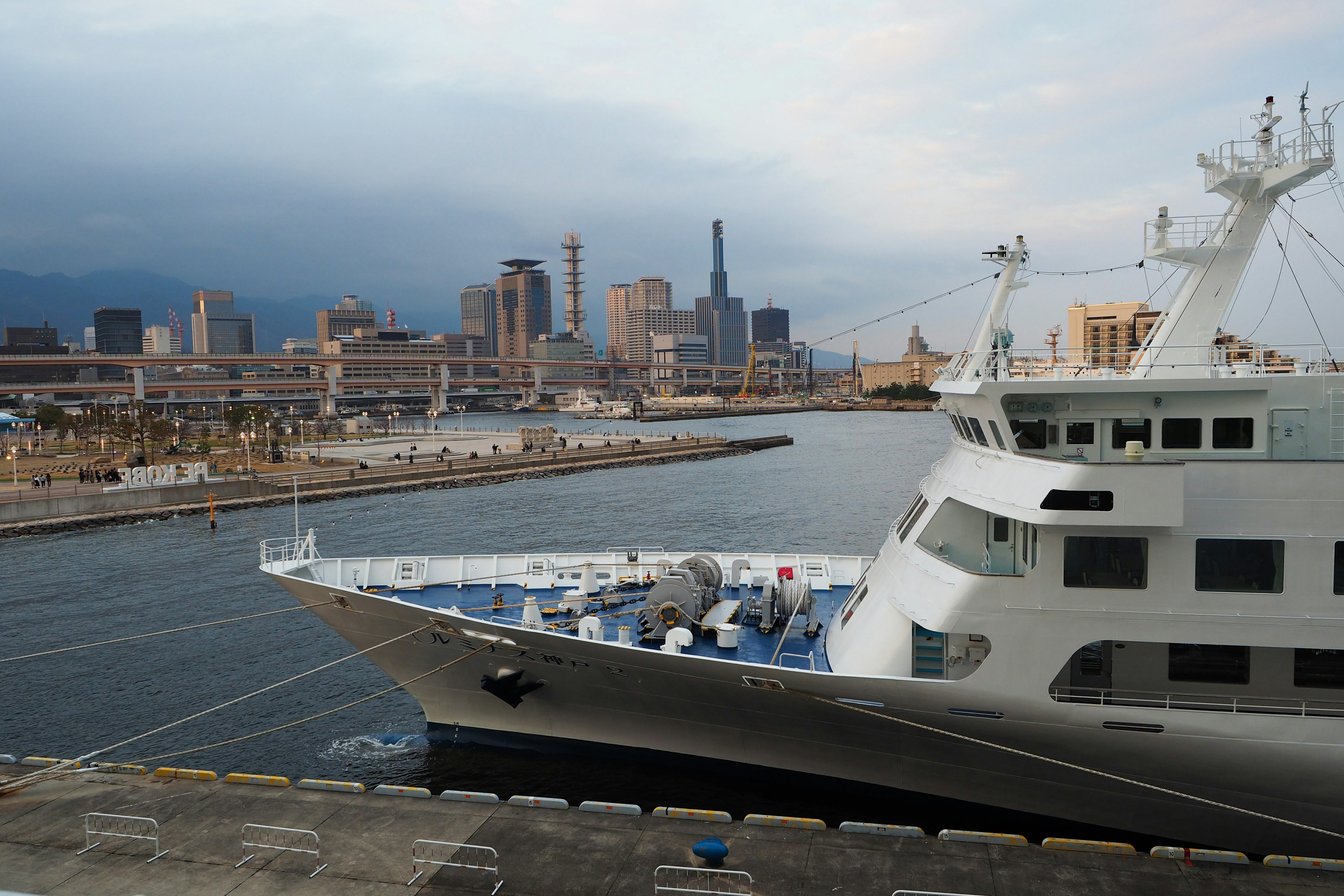 Boat docked at the harbor with city skyline in the background