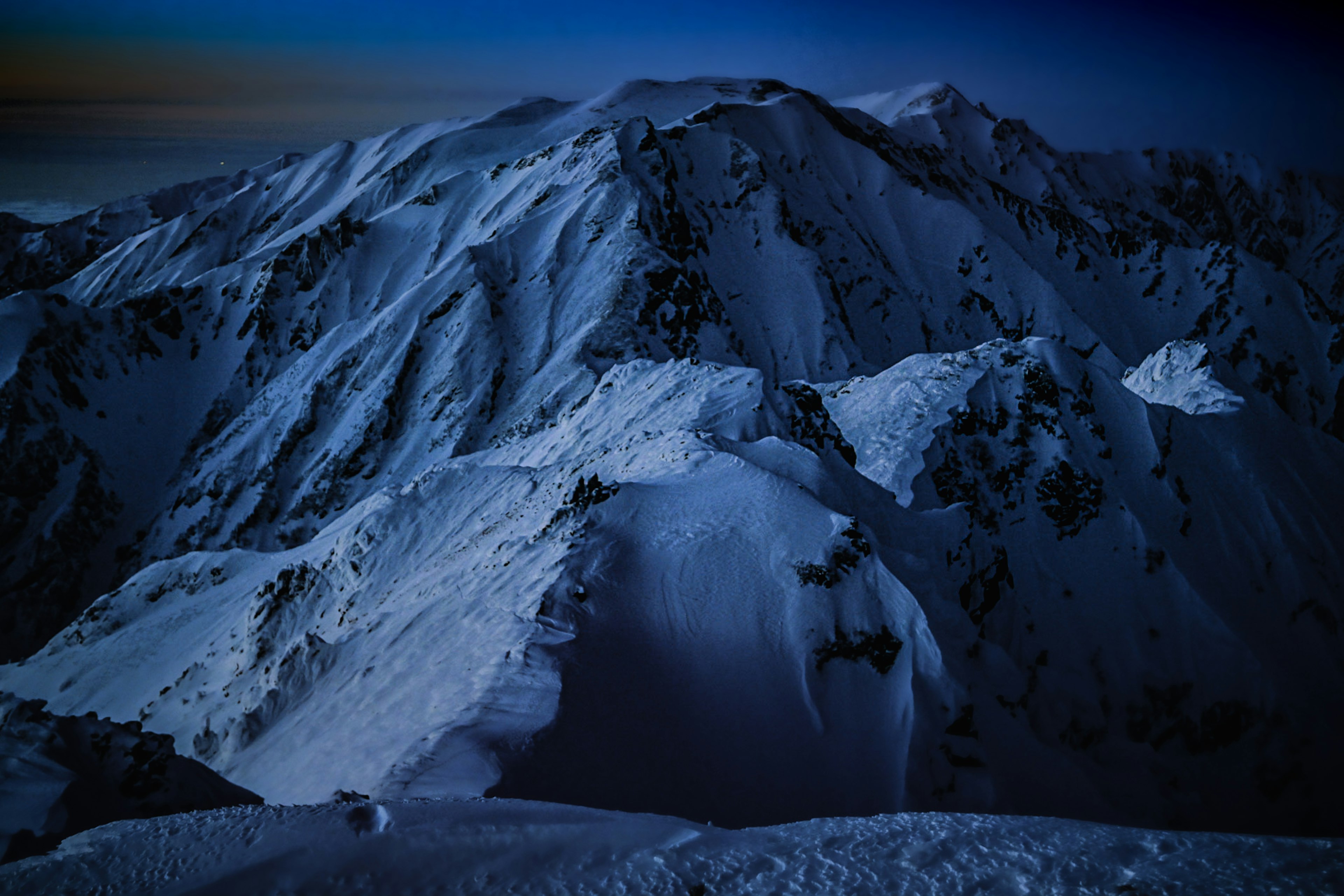 Snow-covered mountain landscape at night