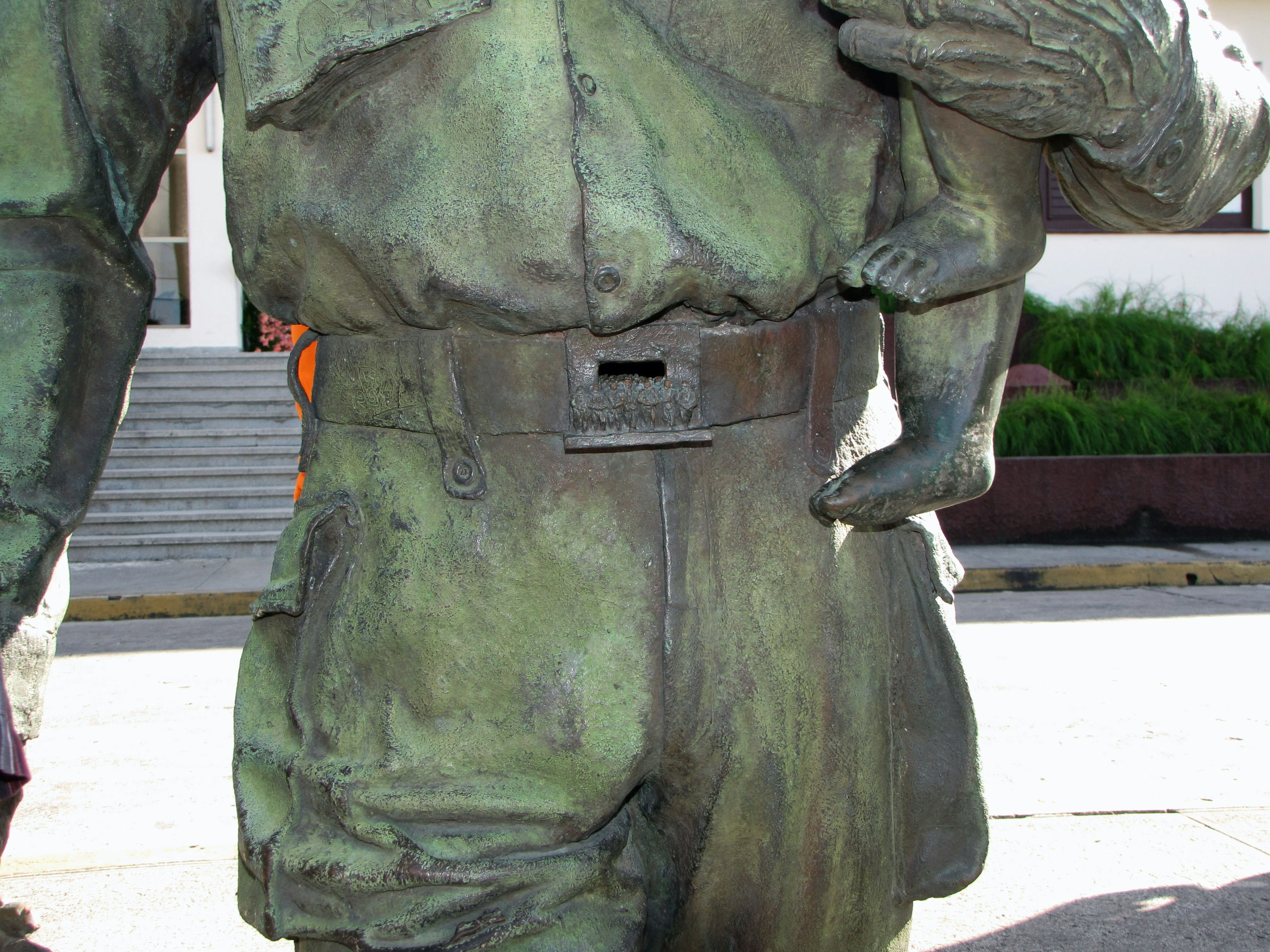 Bronze statue of a man holding a child