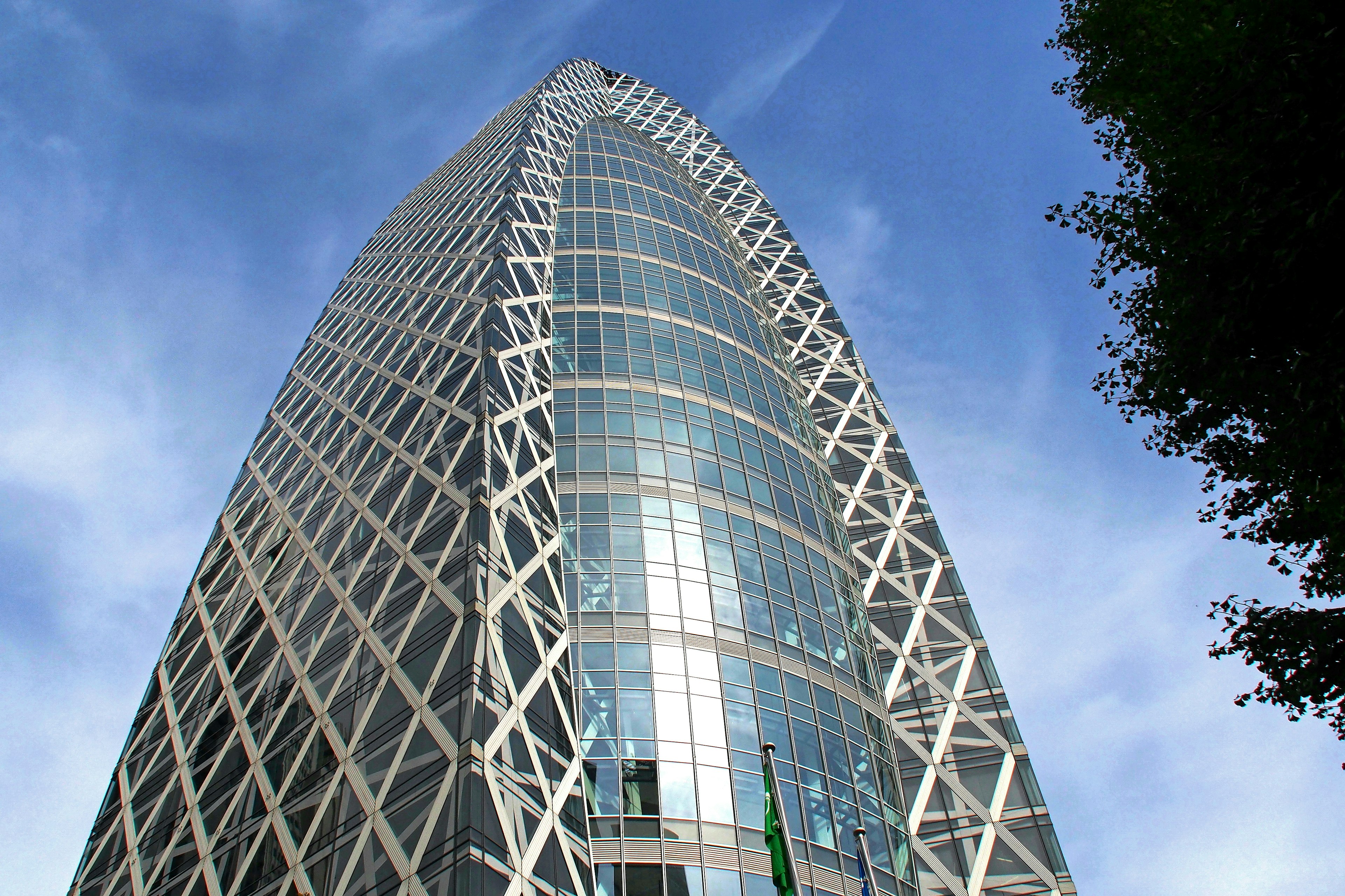 Modern skyscraper with a unique diagonal design under a blue sky