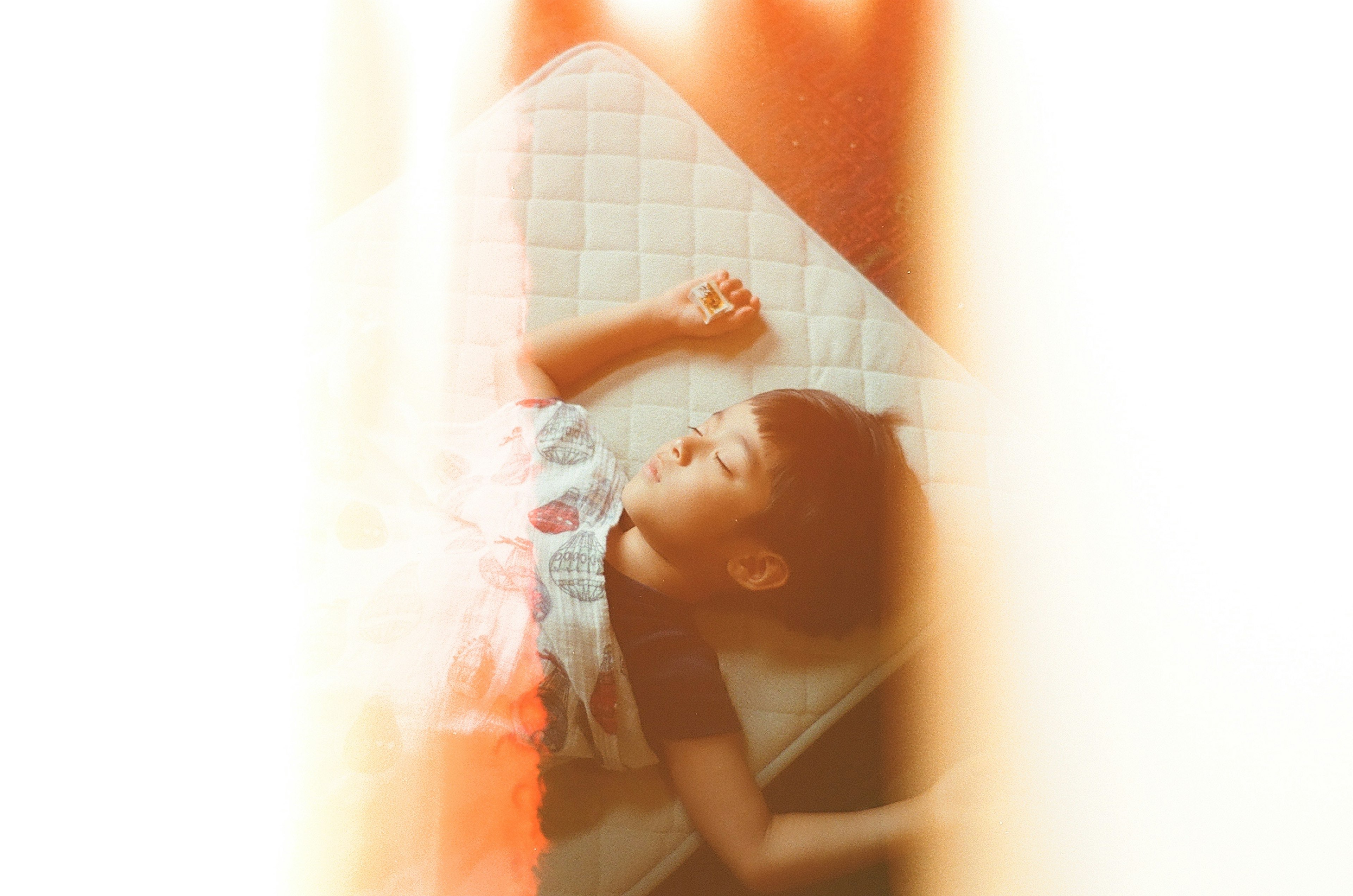 A baby relaxing on a soft mattress with a peaceful expression