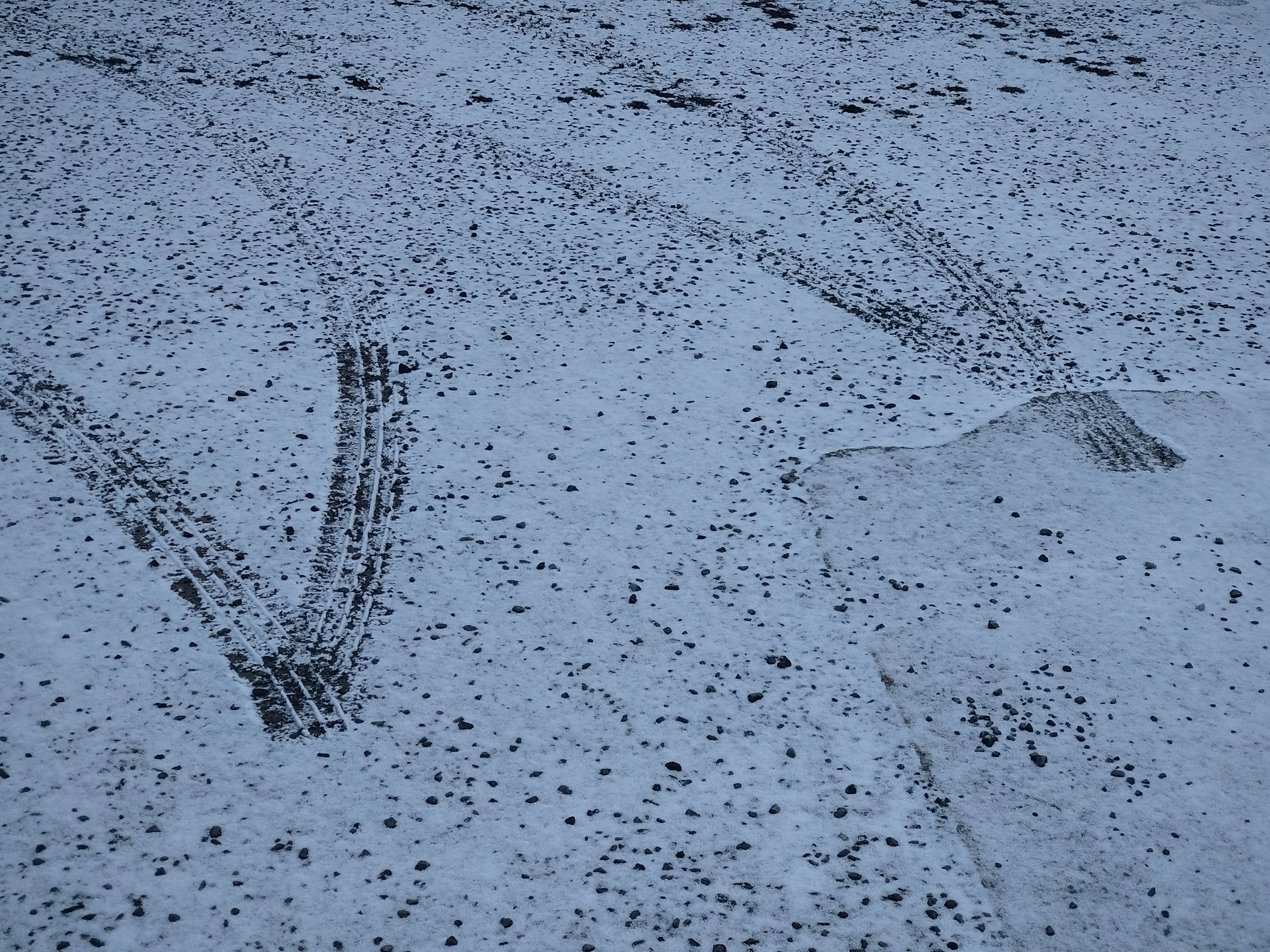 Tire tracks visible on a snowy surface