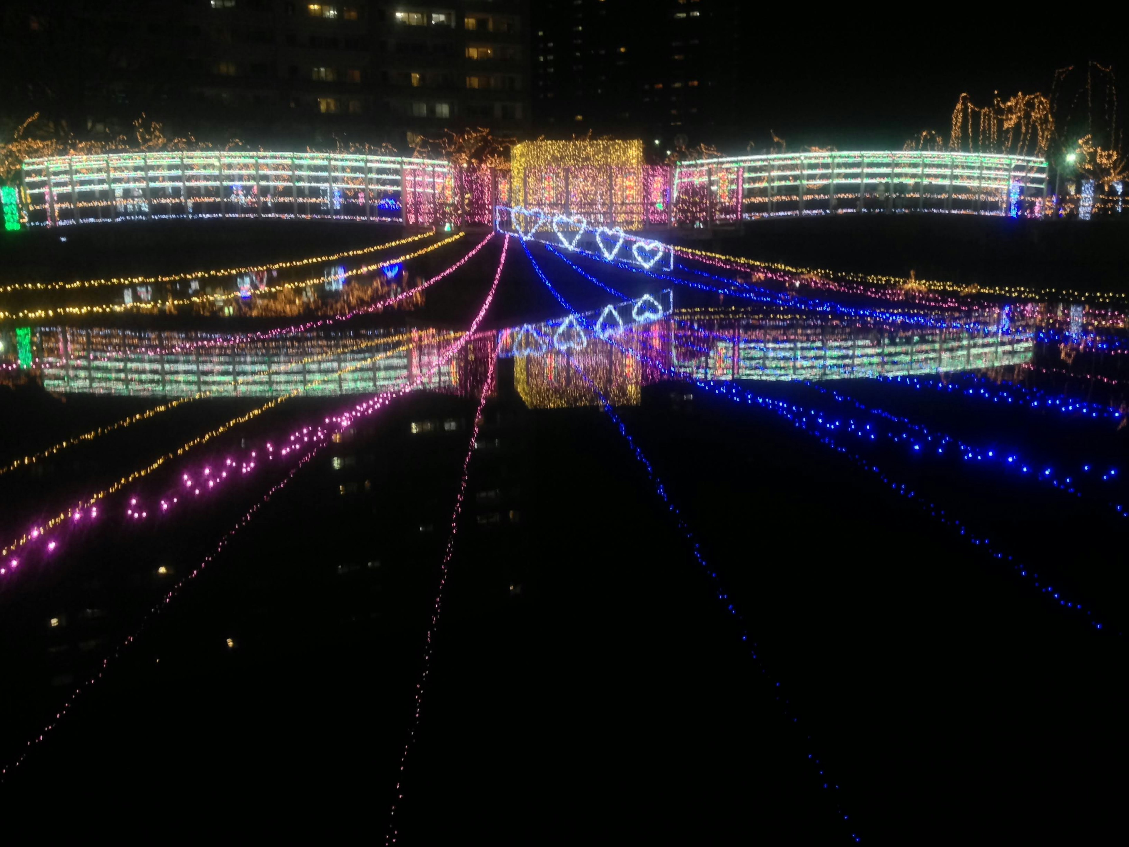 Beautiful reflection of colorful lights on the water at night