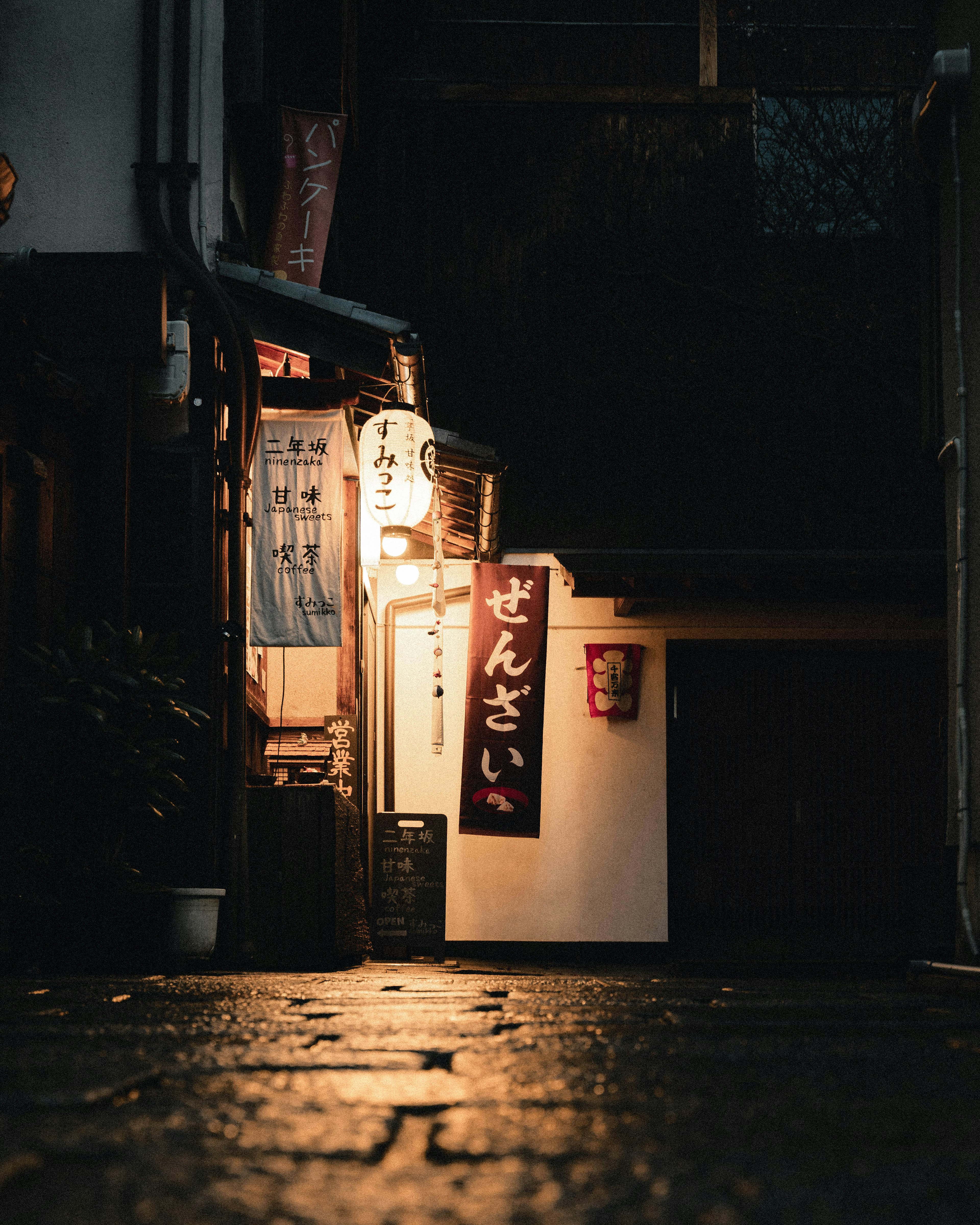 Eksterior izakaya Jepang di jalan gelap Penerangan lembut menyoroti papan nama