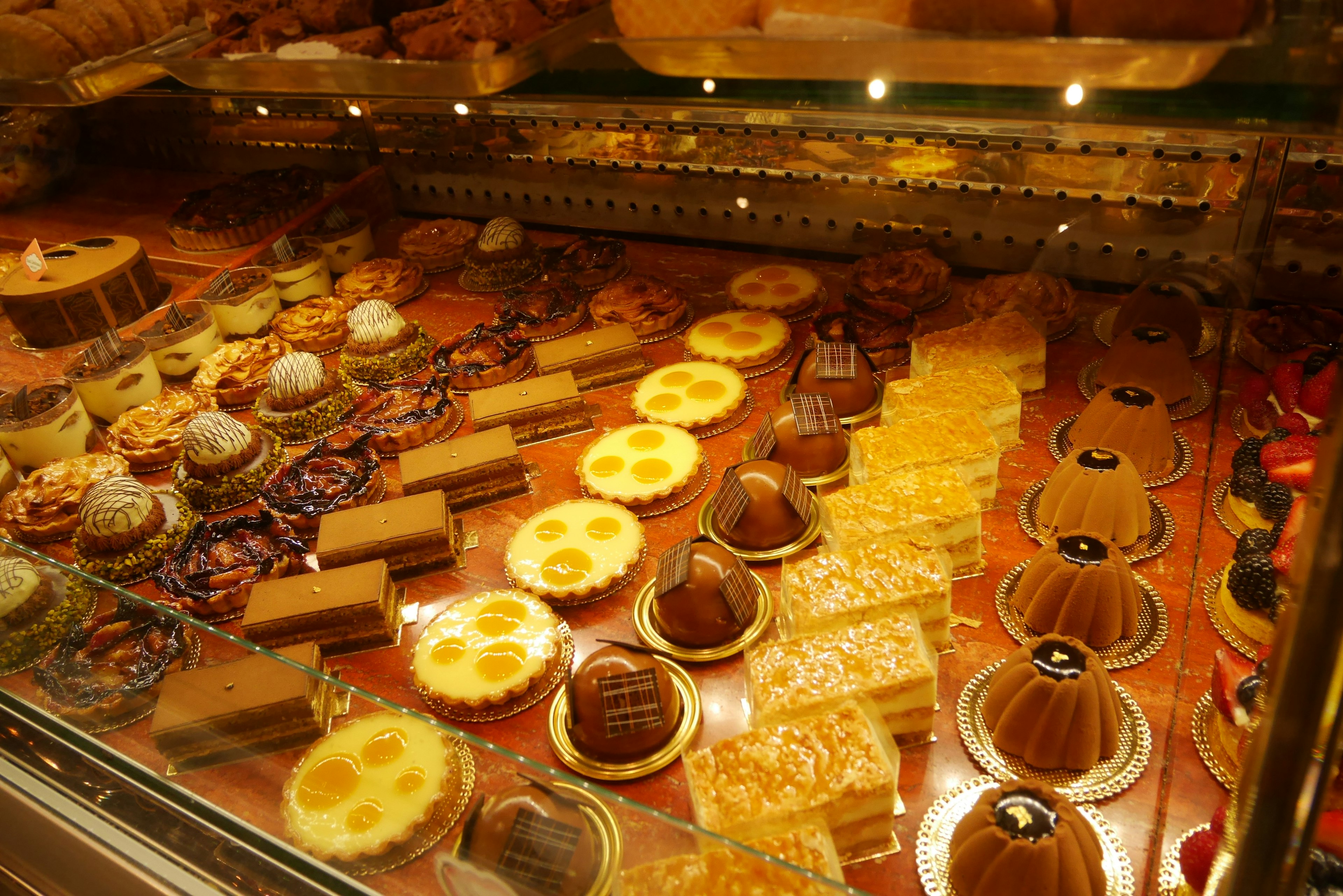 Display case filled with colorful desserts and cakes