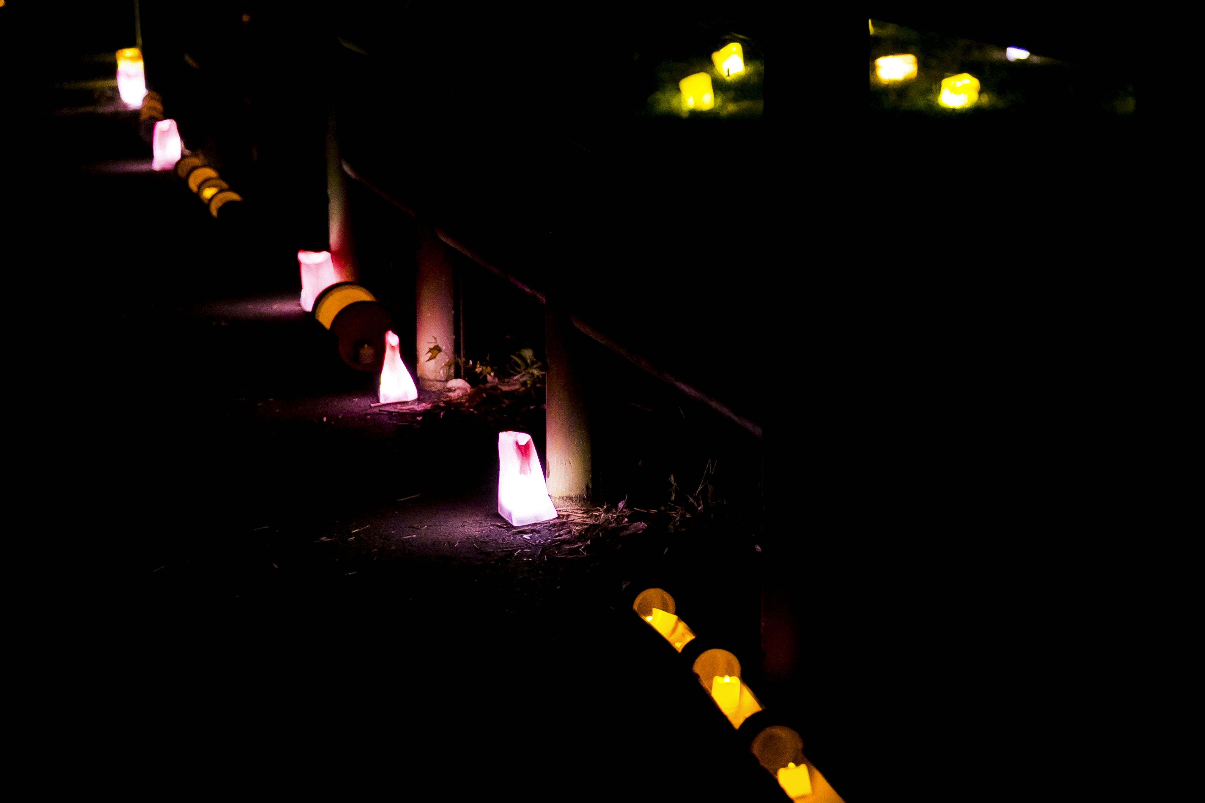 A scenic view of colorful lanterns glowing in the darkness