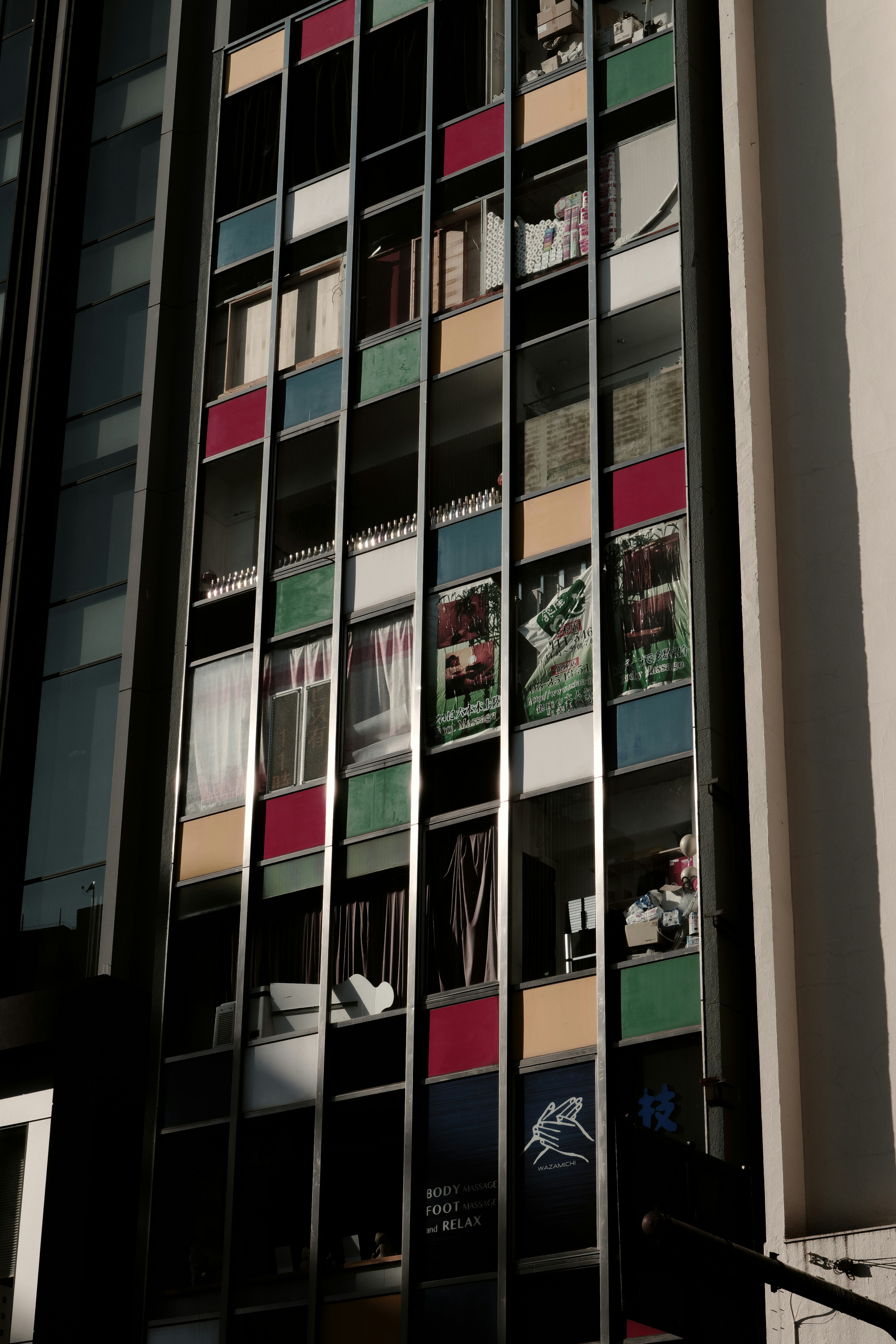 Colorful facade of a building with various window panels and decorations