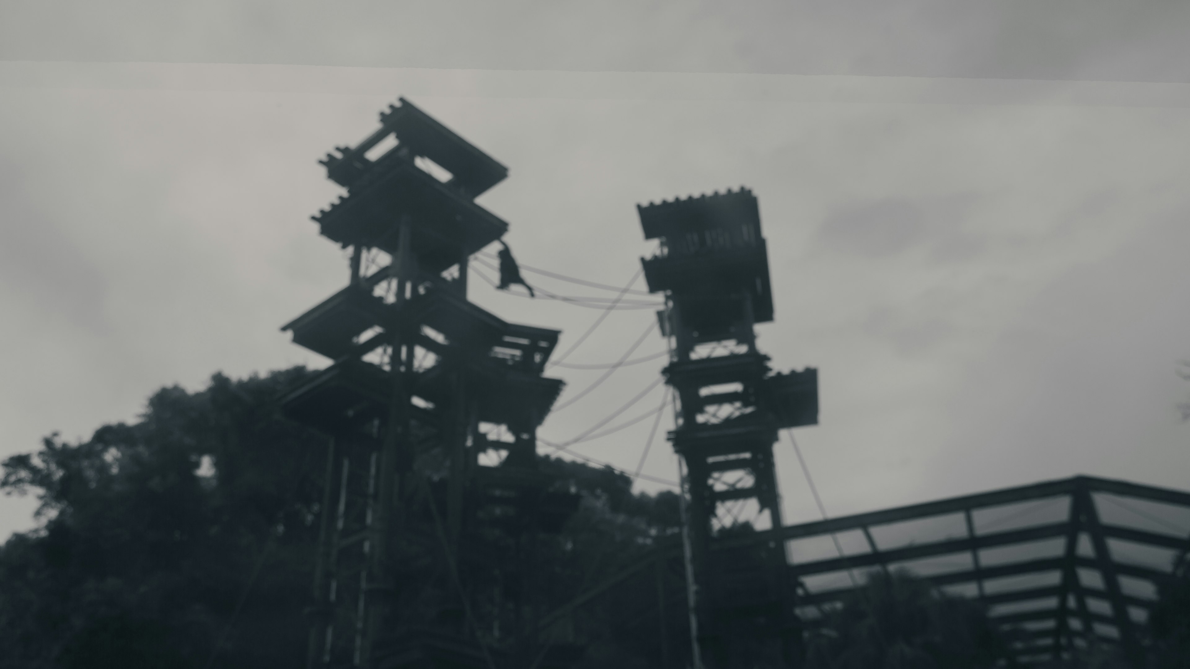 Tall towers connected by ropes against a cloudy sky