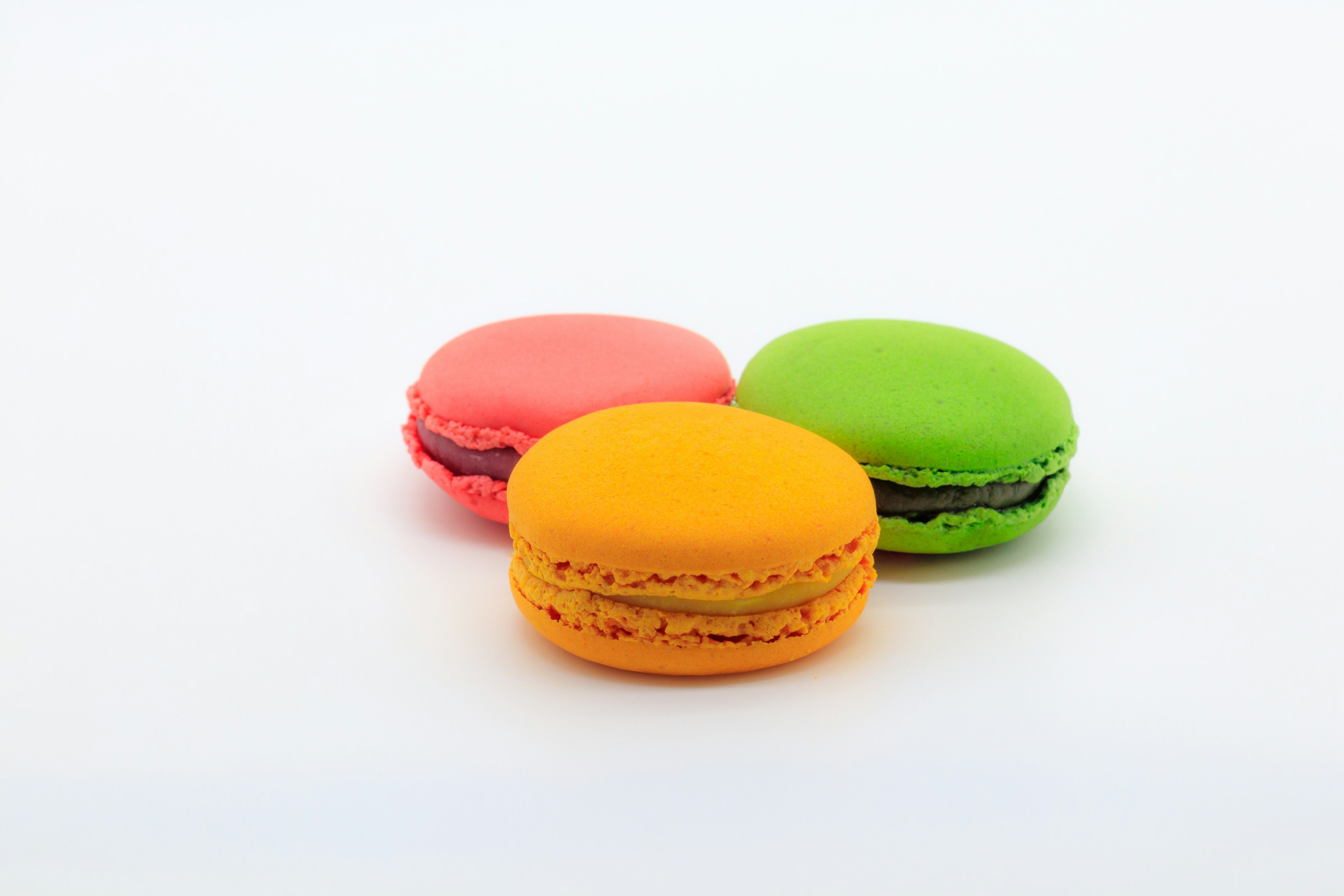 Macaron berwarna-warni diletakkan di atas latar belakang putih