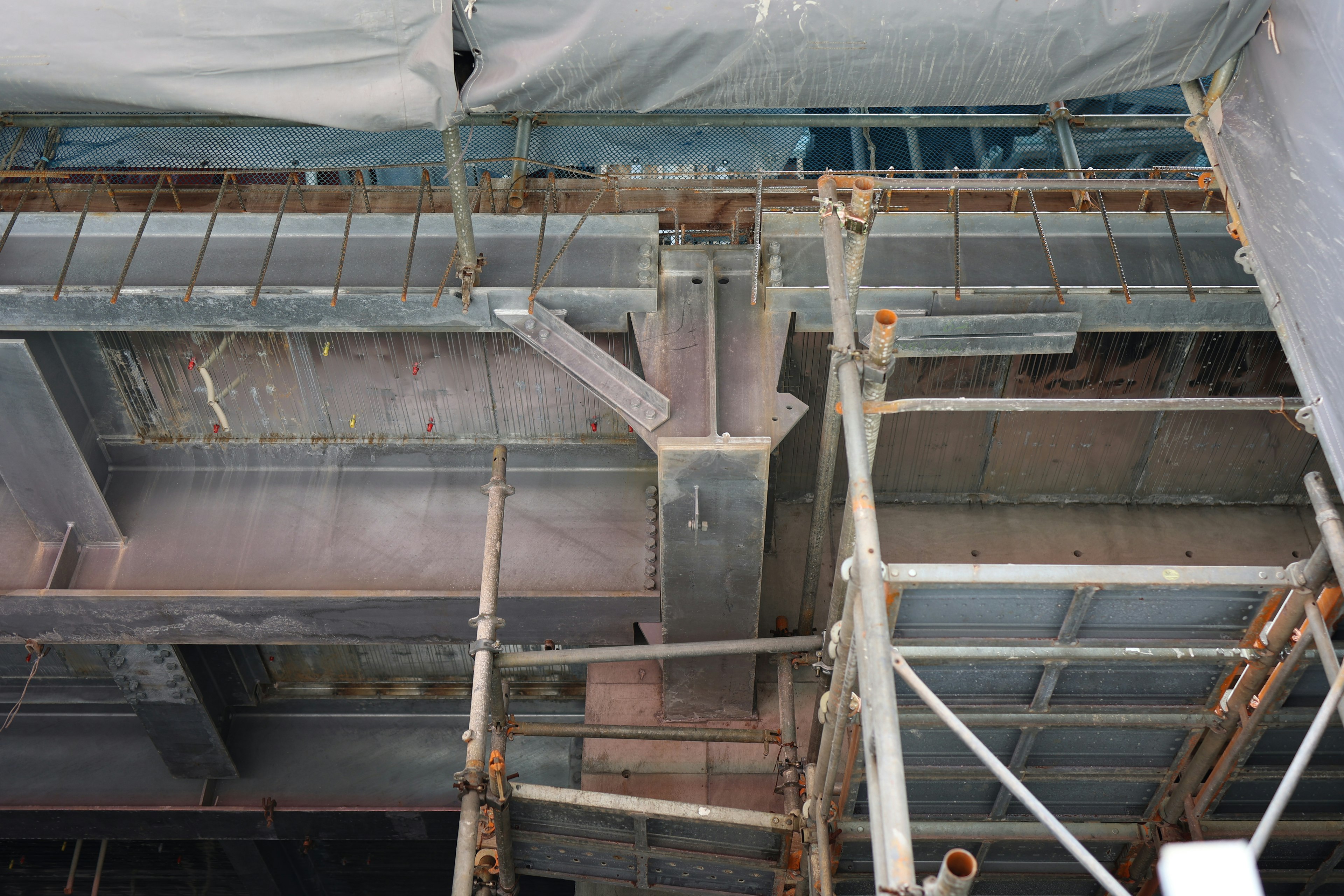 Detailed view of steel structures and scaffolding at a construction site