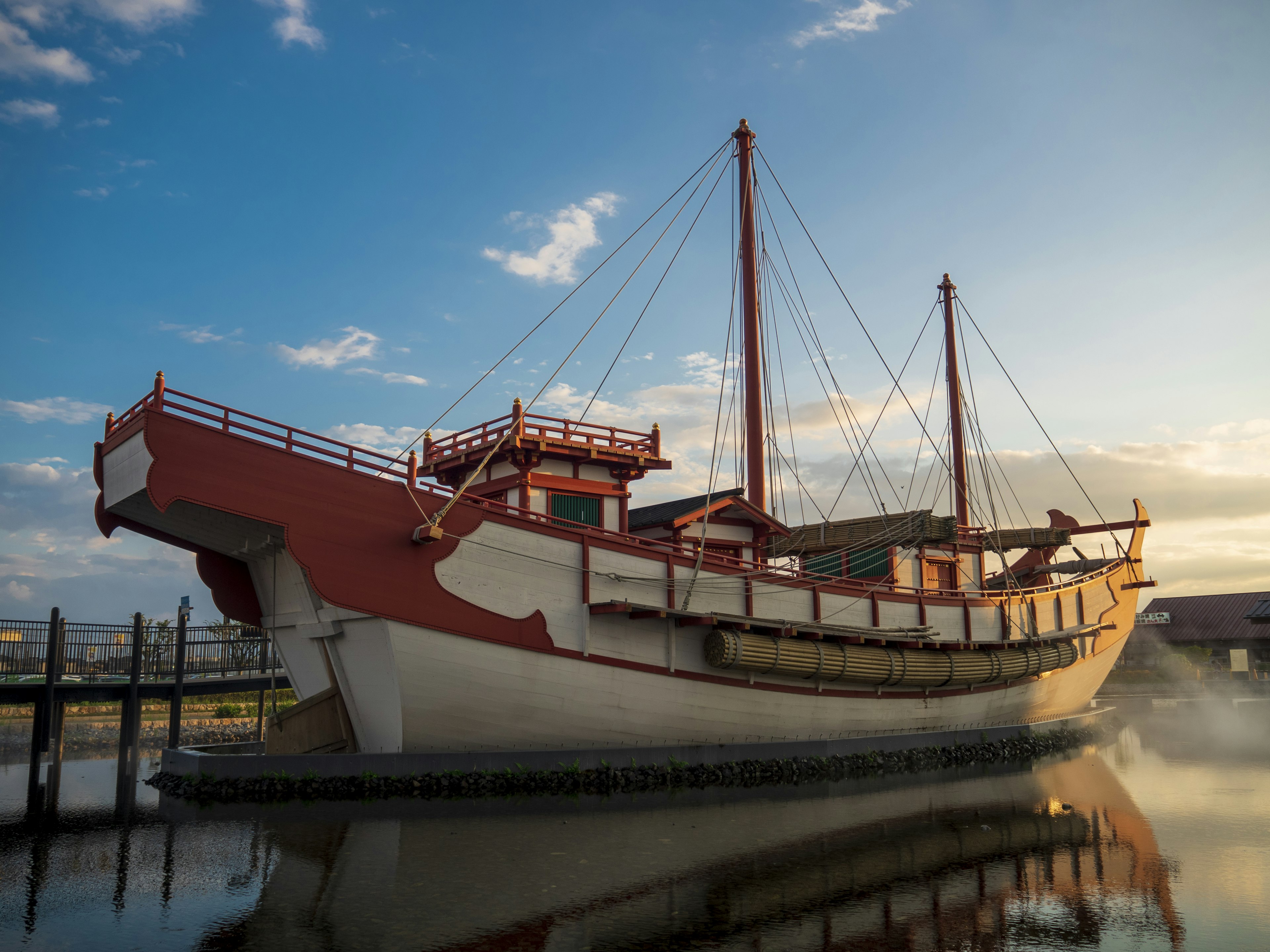 A beautiful ship floating on calm waters during sunset