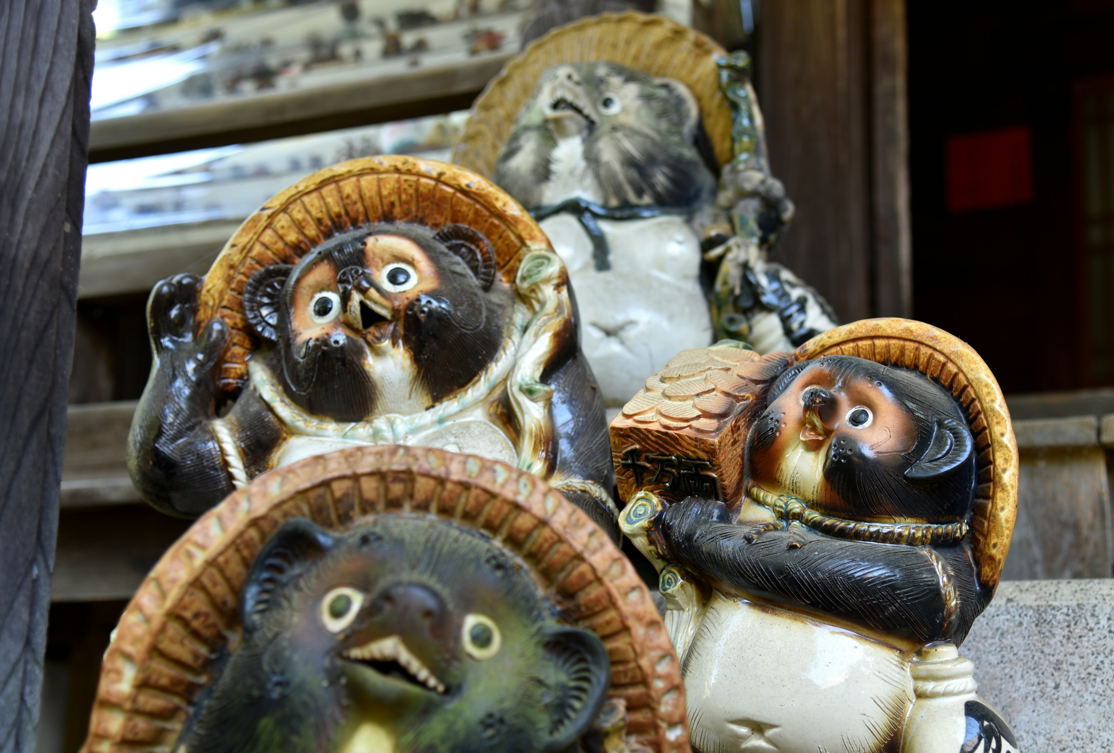 Collection of tanuki figurines with expressive faces