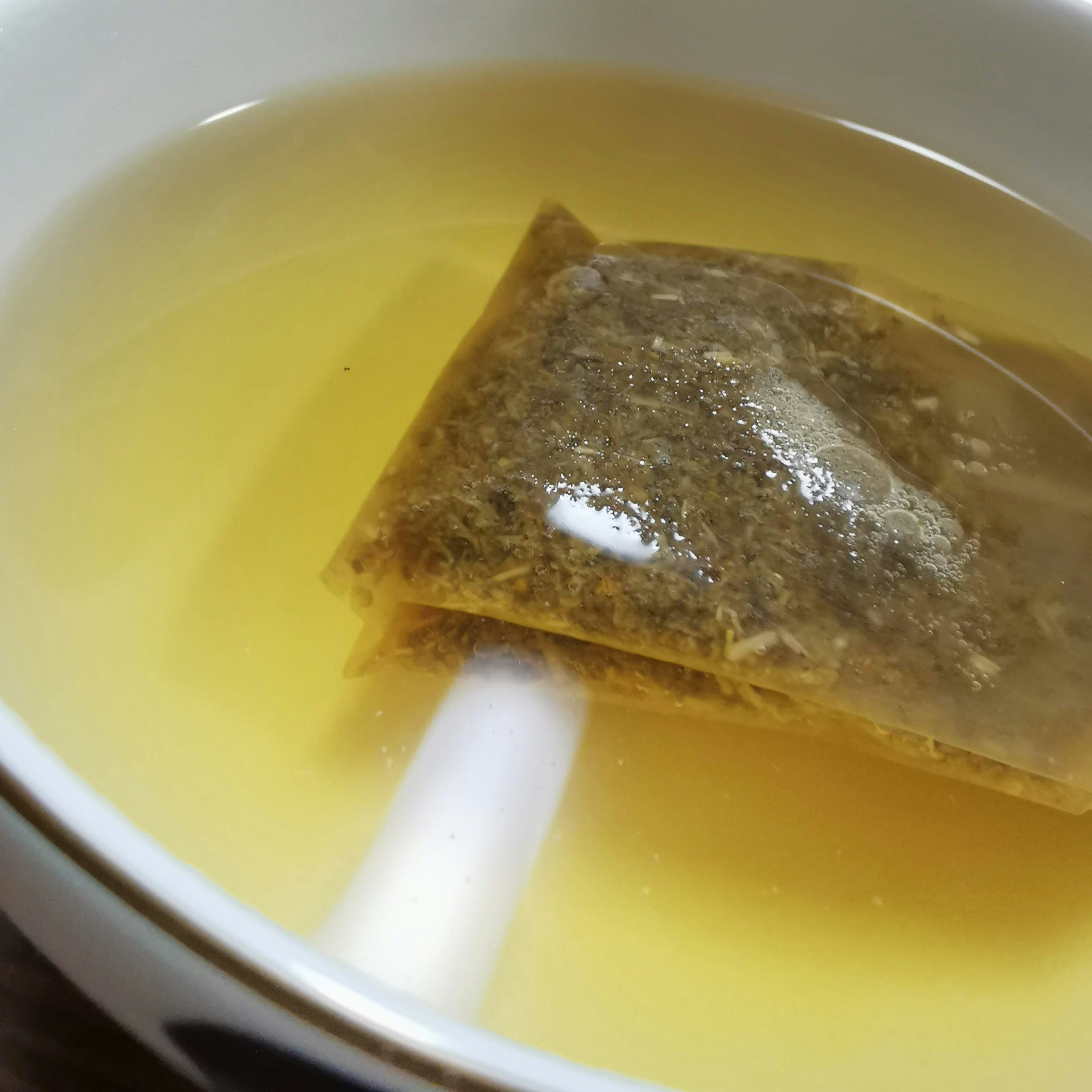 A tea bag submerged in a clear liquid