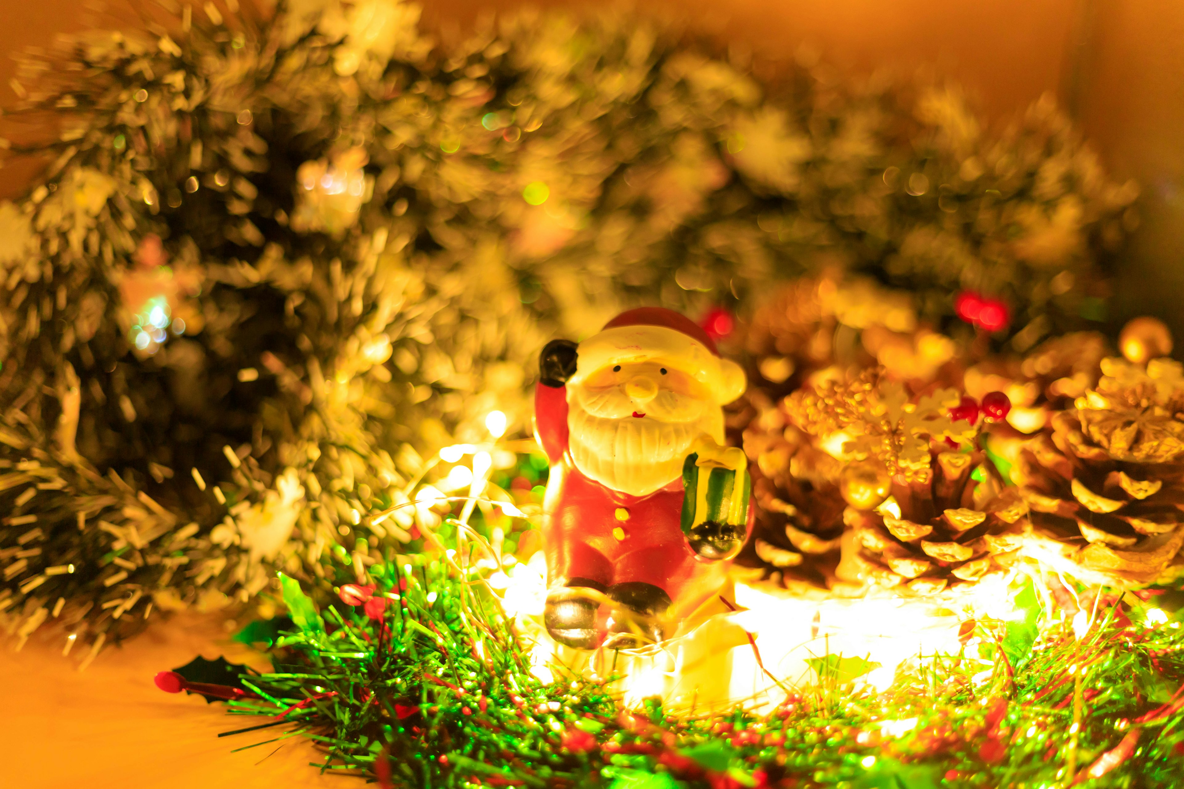 Santa Claus figurine surrounded by Christmas decorations