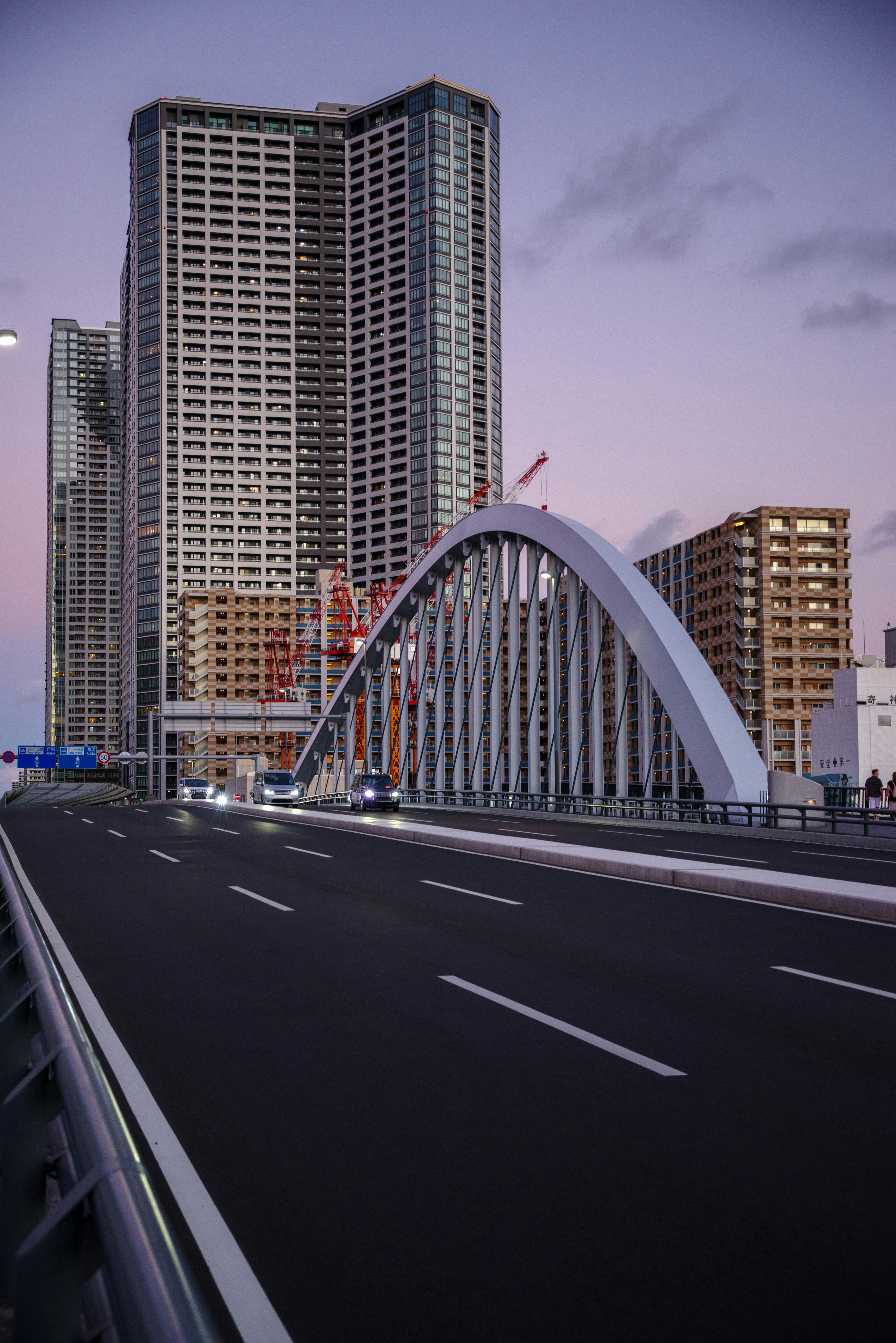 Urban landscape featuring modern buildings and an arch bridge