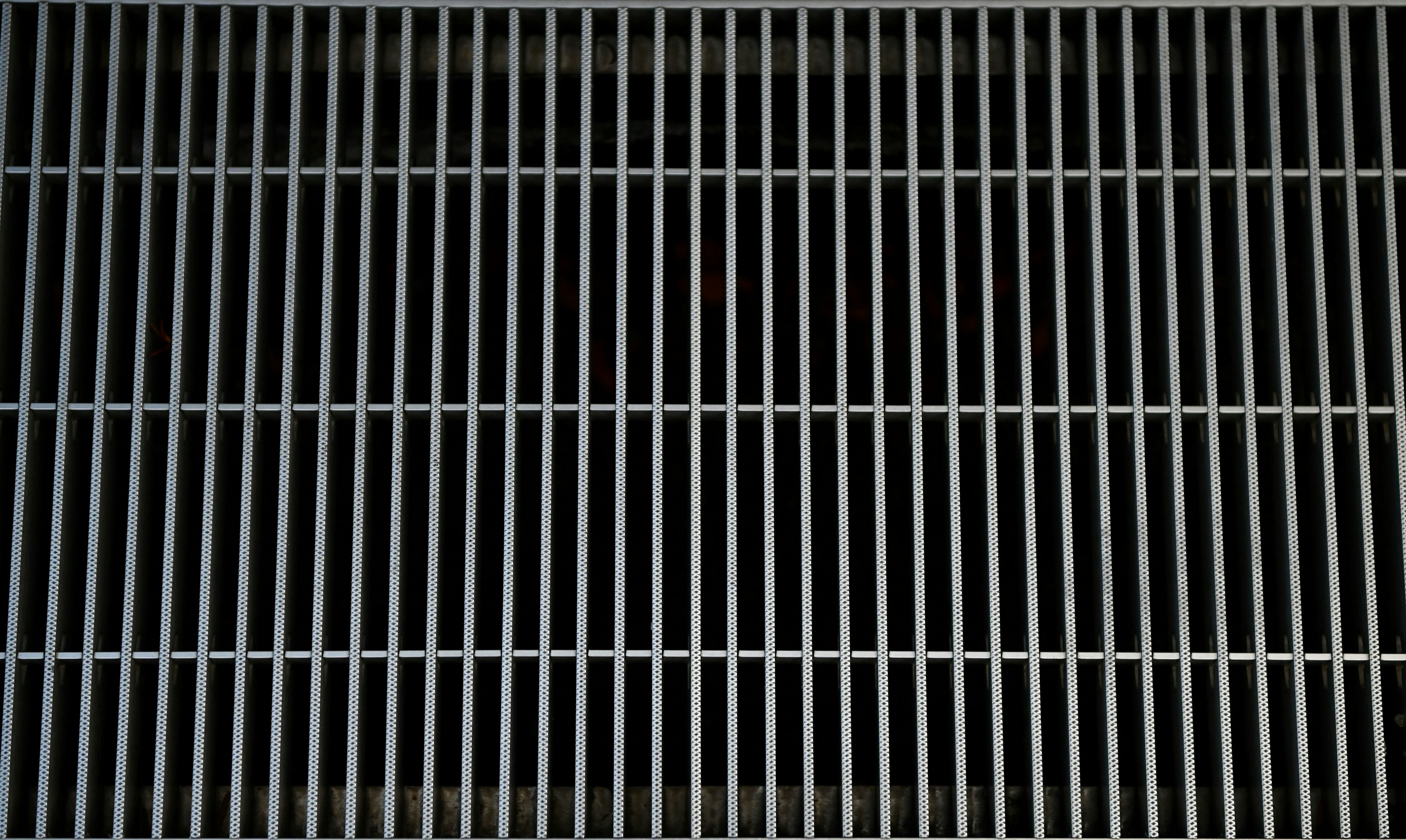 White metal grid pattern on a black background