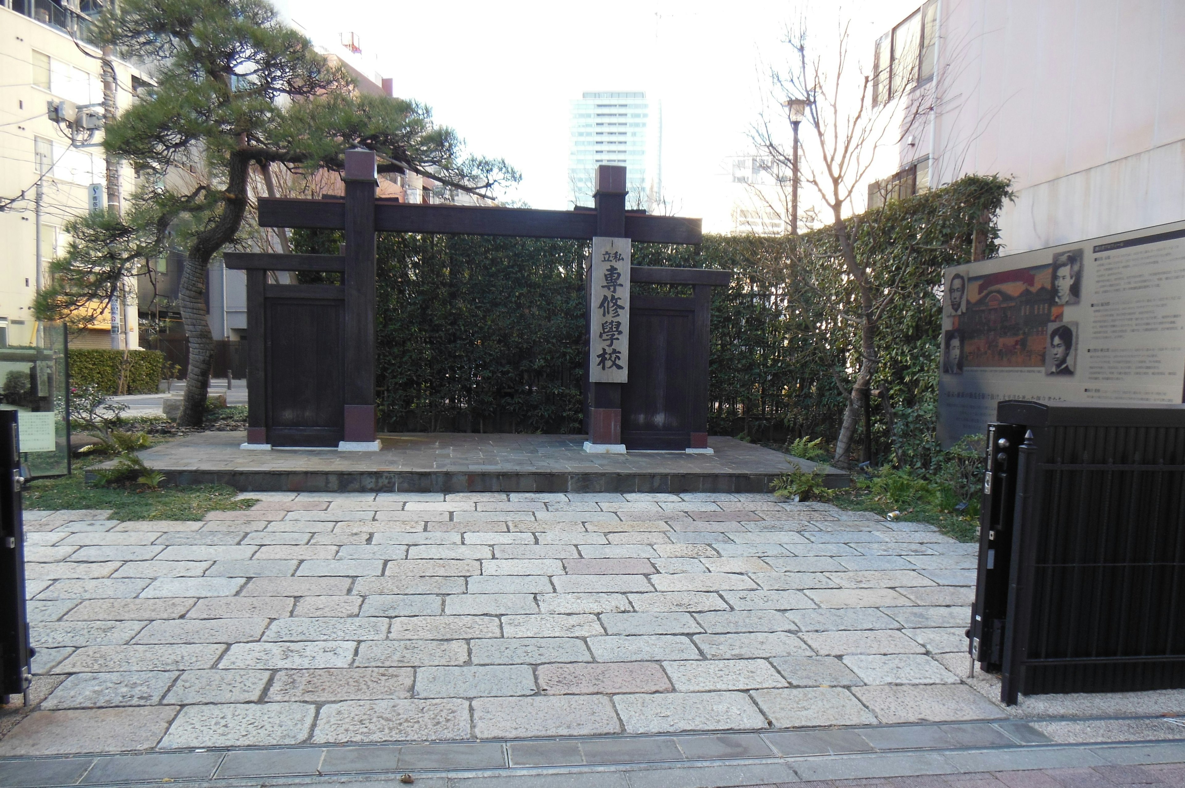 Traditional gate at the entrance of a quiet park with stone pavement