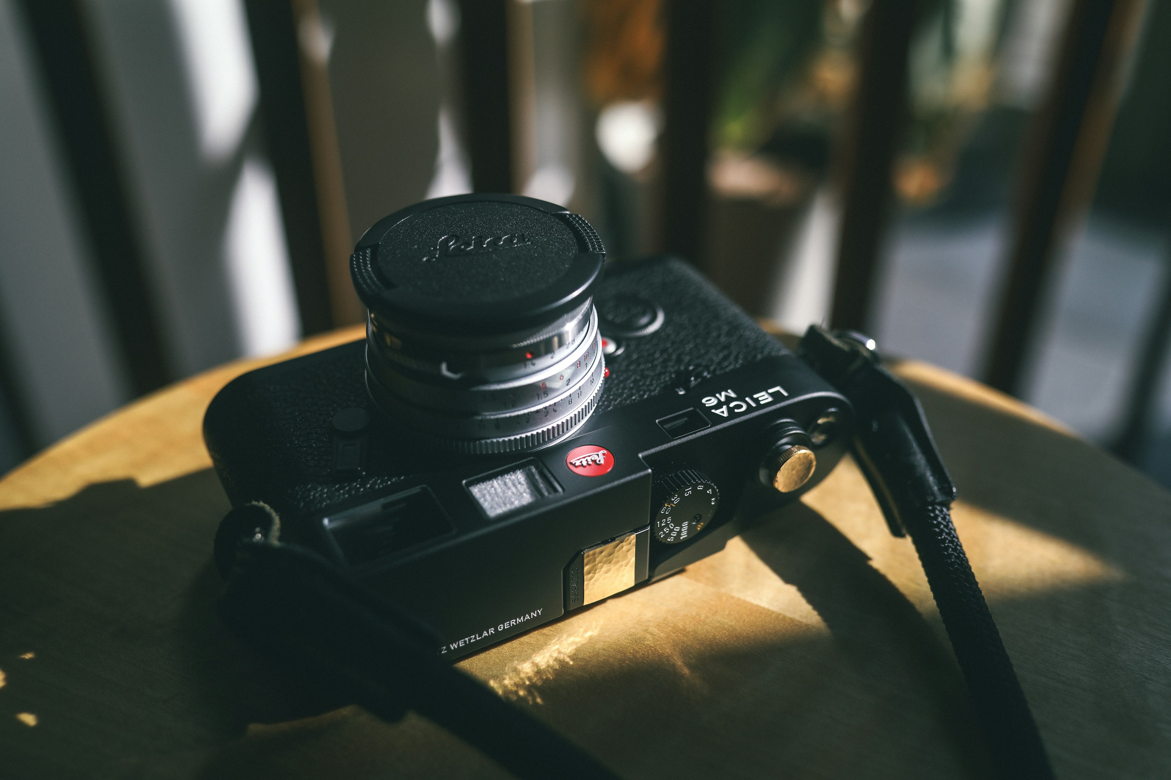 Black camera placed on a wooden table