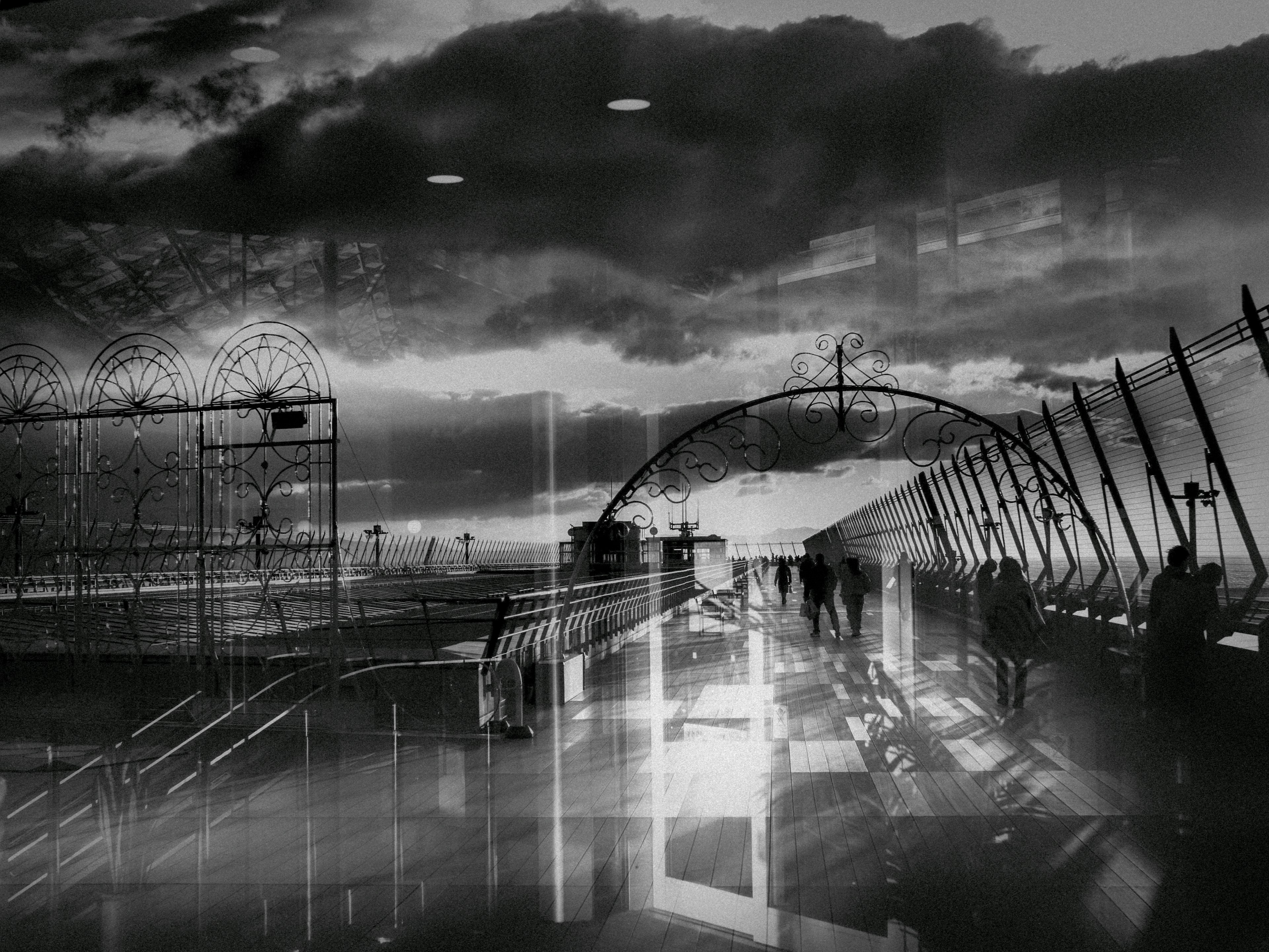 Black and white scene with people walking Transparent structures and dynamic clouds