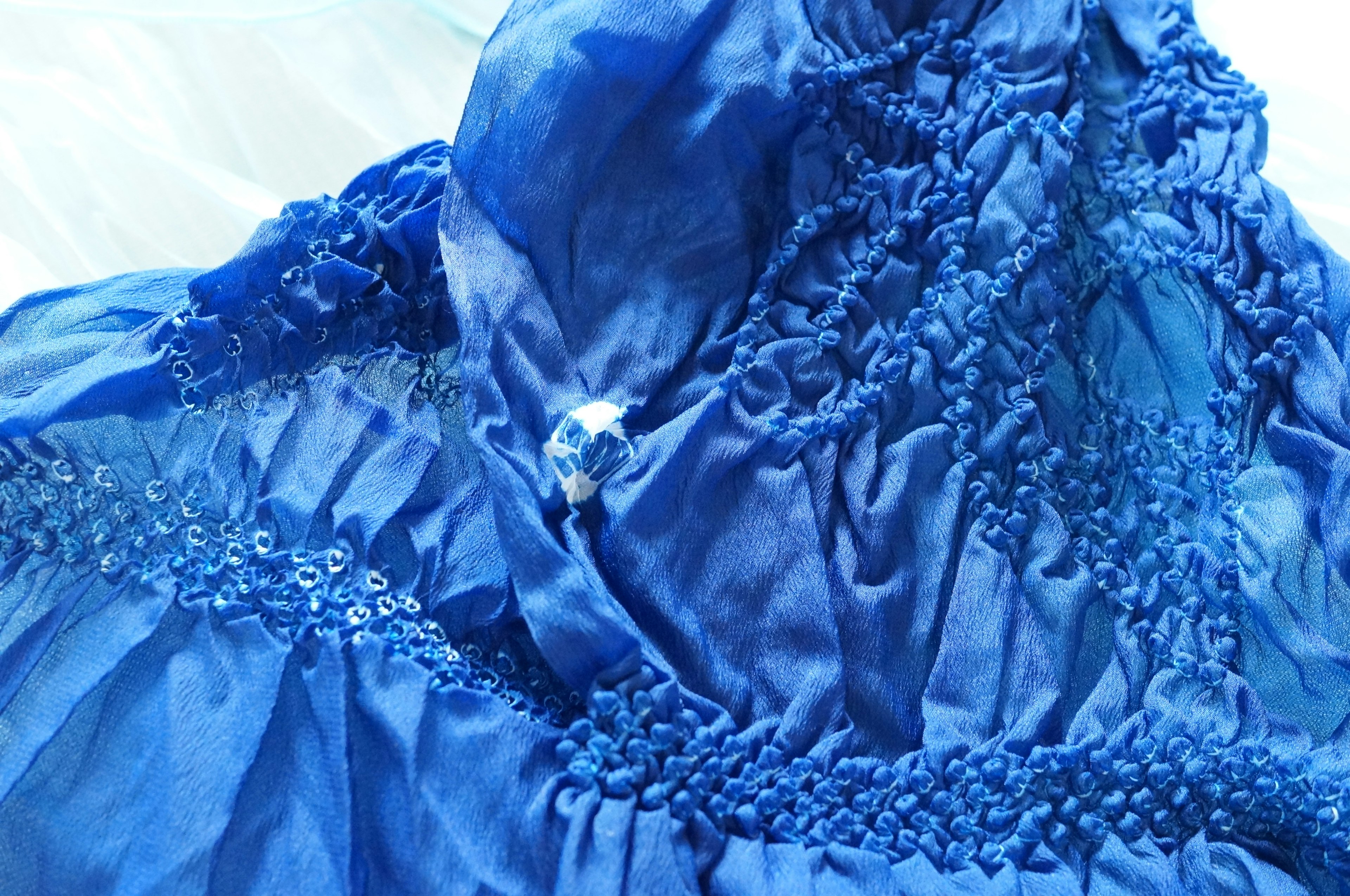 Detailed texture and design of a blue dress fabric