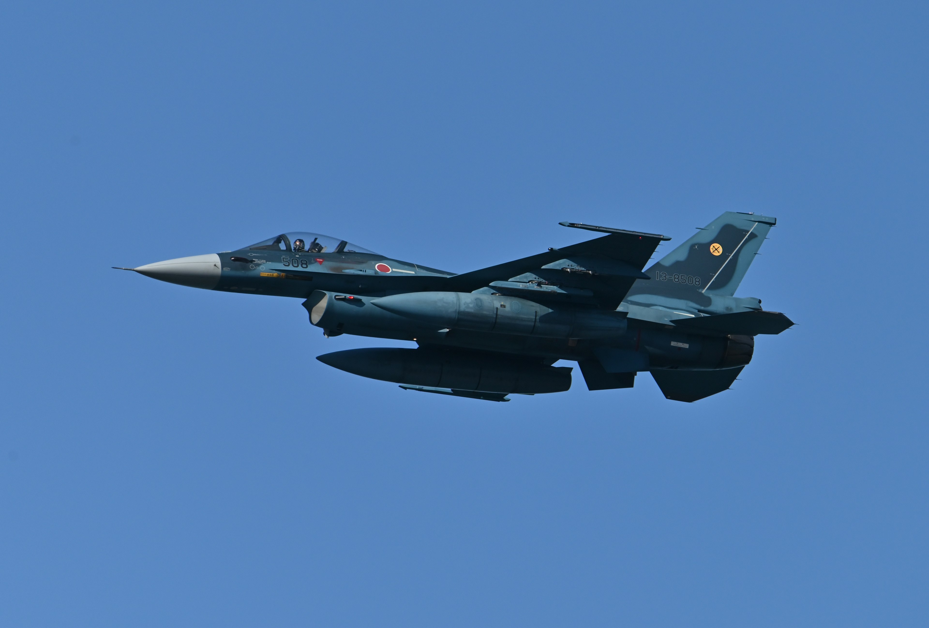 F-18 fighter jet flying in a clear blue sky