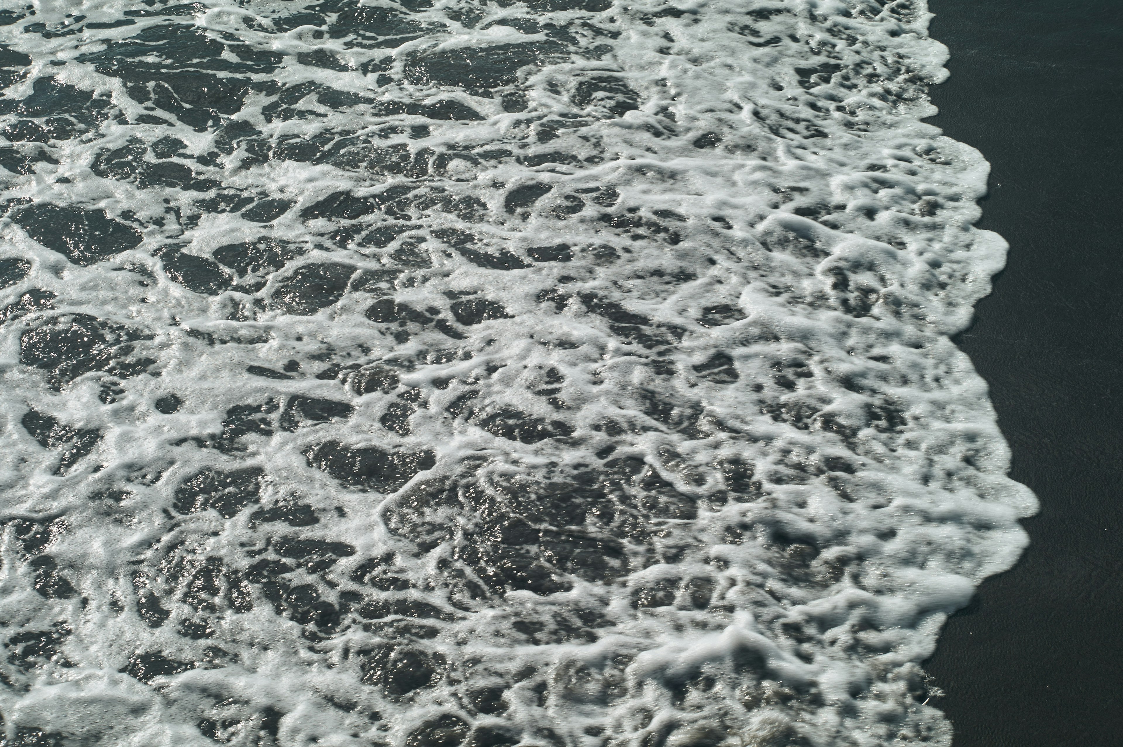 Close-up of ocean waves creating foam on the water surface