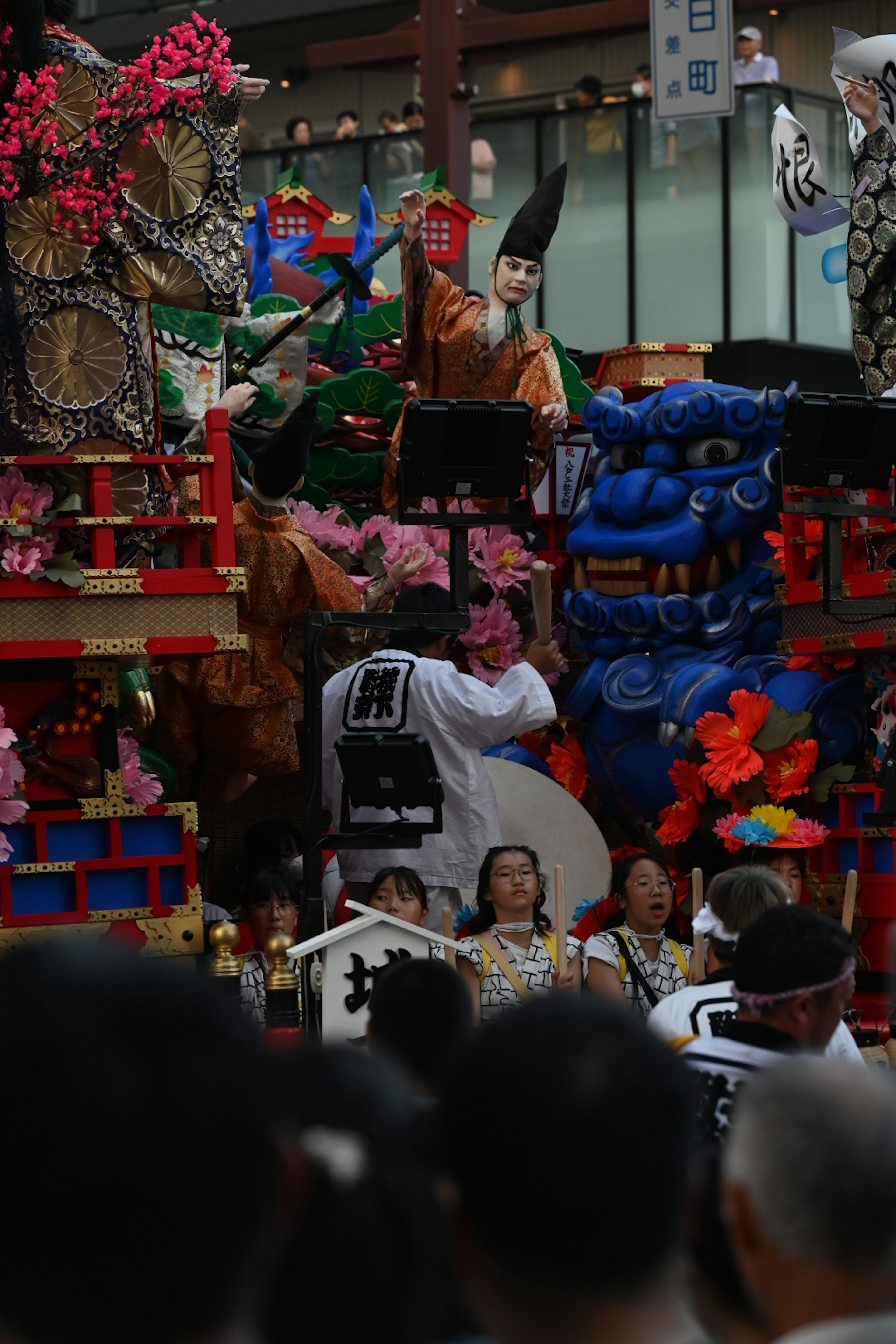 Colorful festival floats and participants gathering in a lively scene