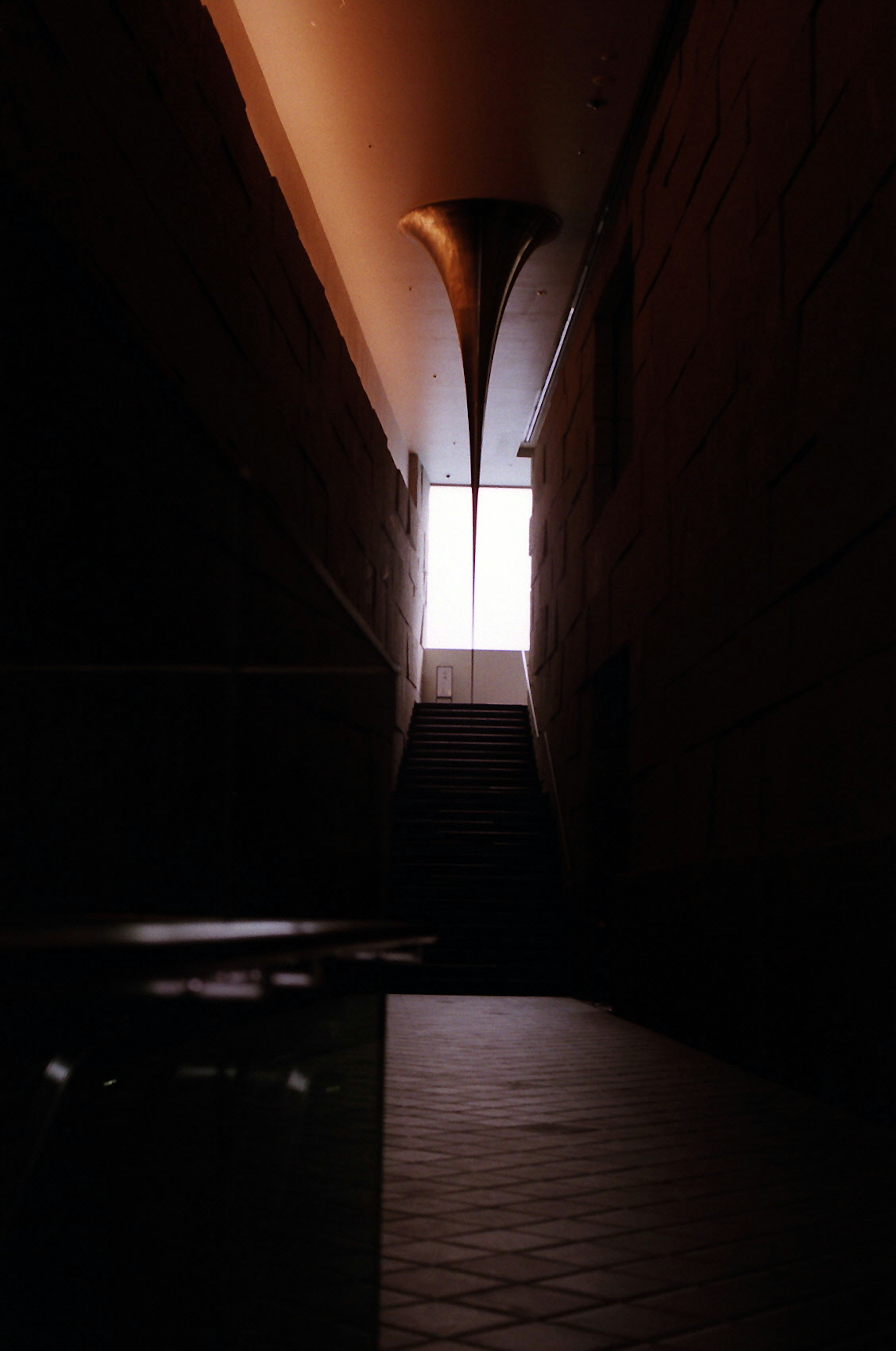 Dimly lit corridor with light streaming in from a window