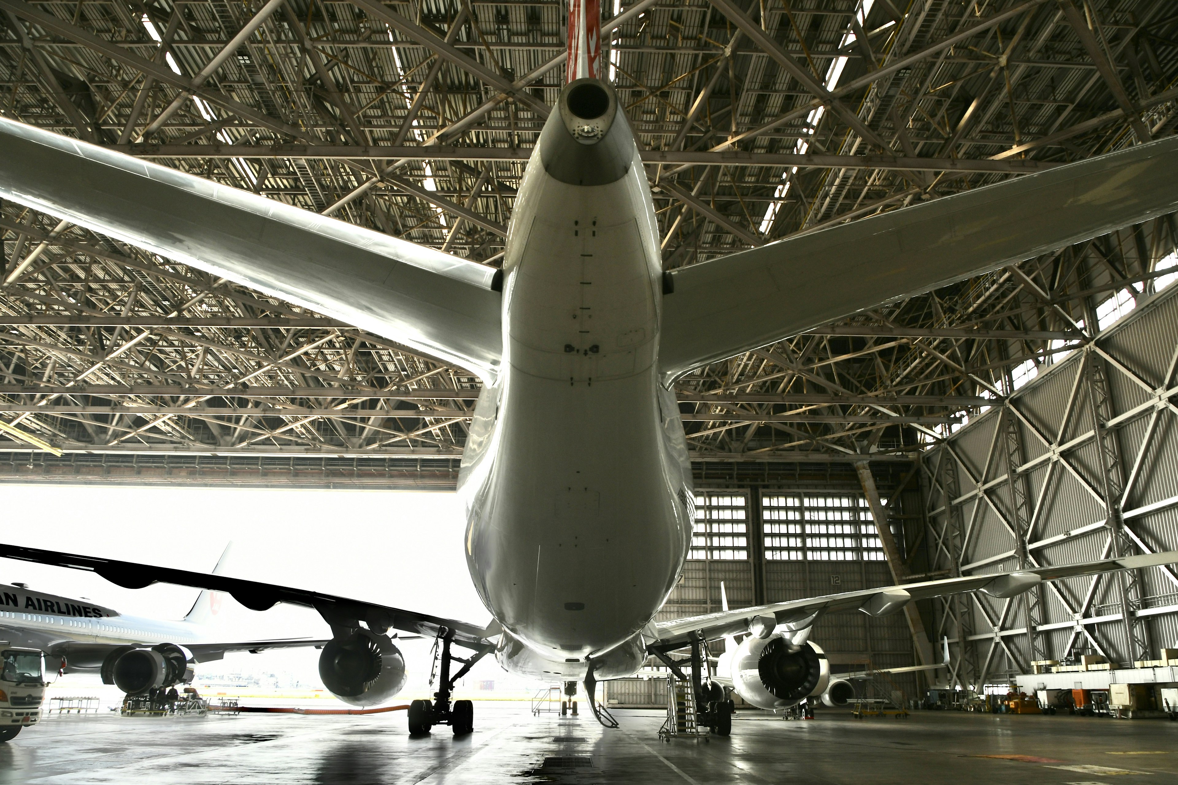 View from below of a large aircraft inside a hangar