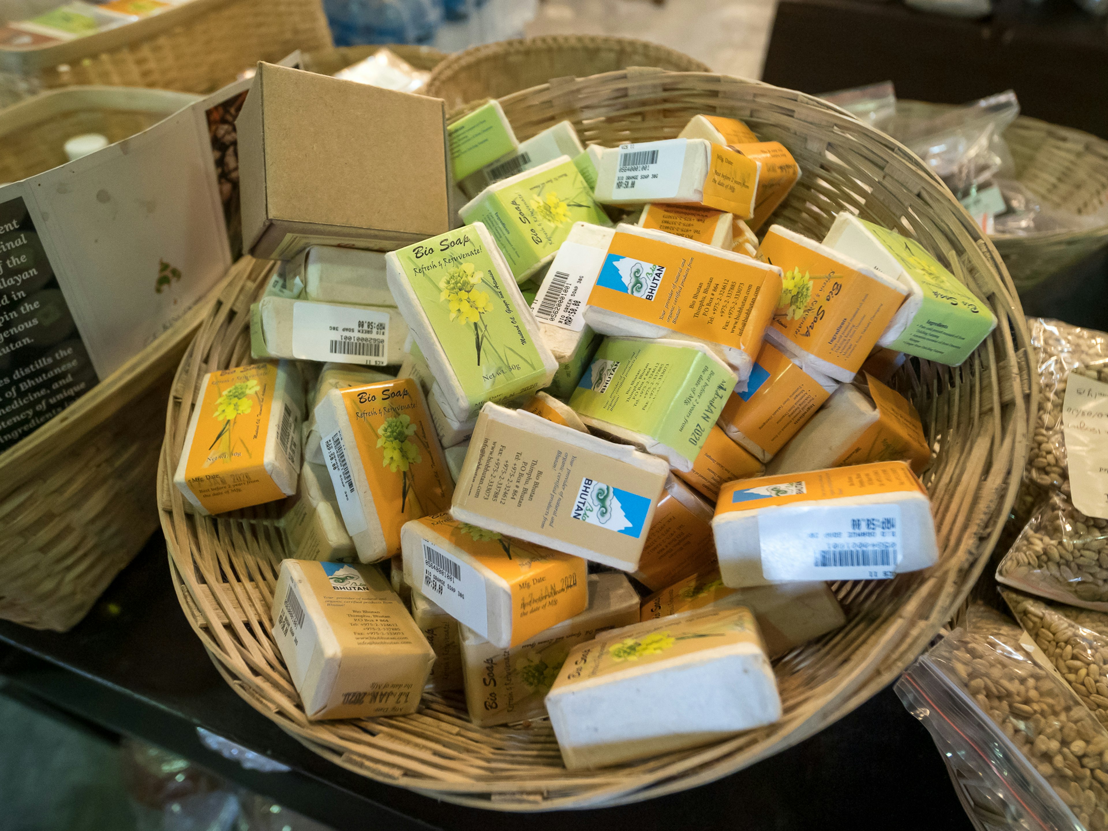 A basket filled with assorted colorful soap bars stacked together