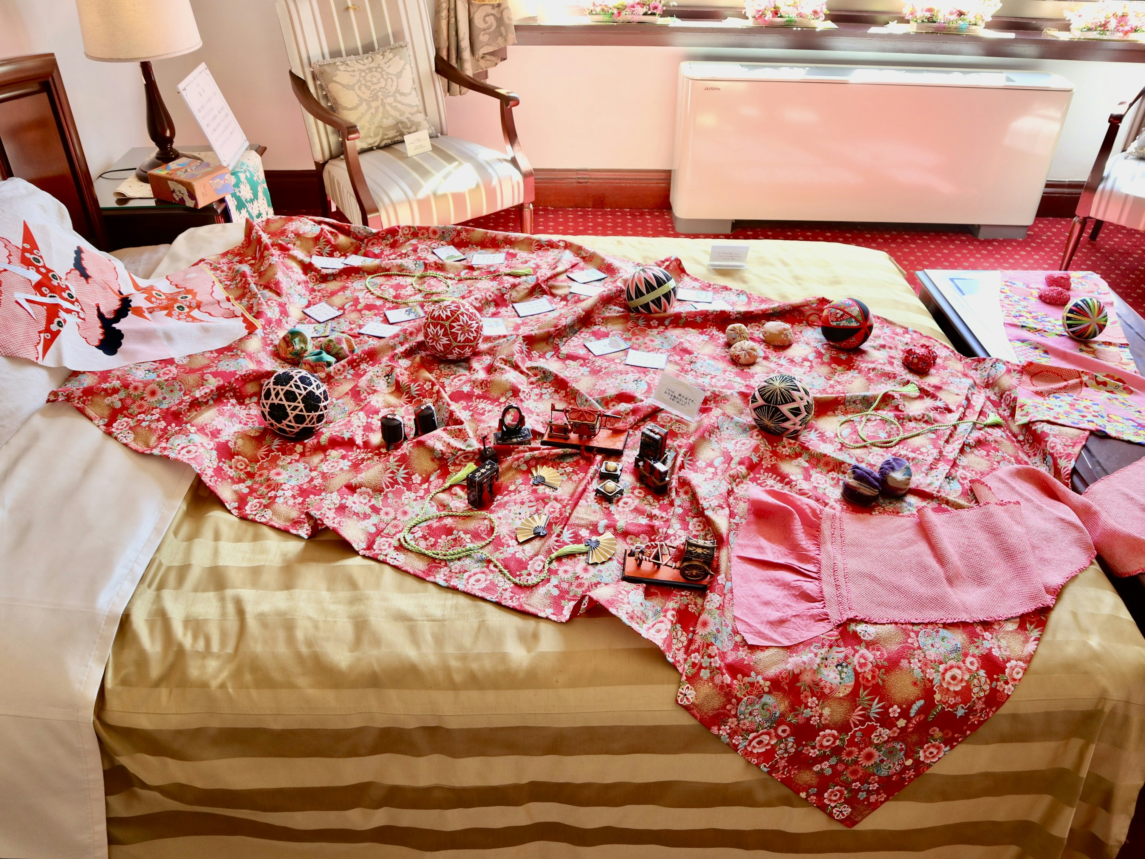 Colorful fabrics and decorative items spread across a bed