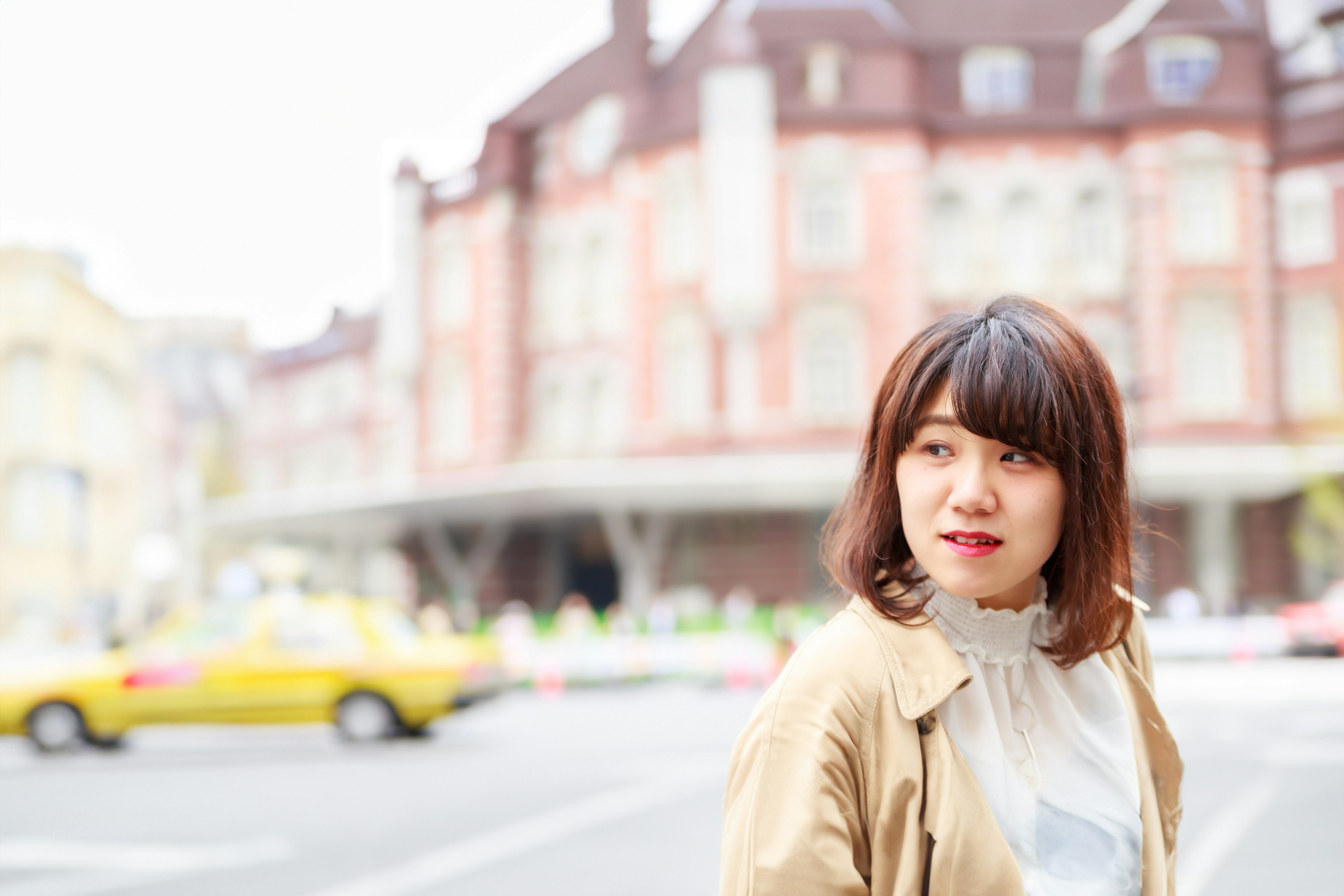 Smiling woman in city with historical building in background