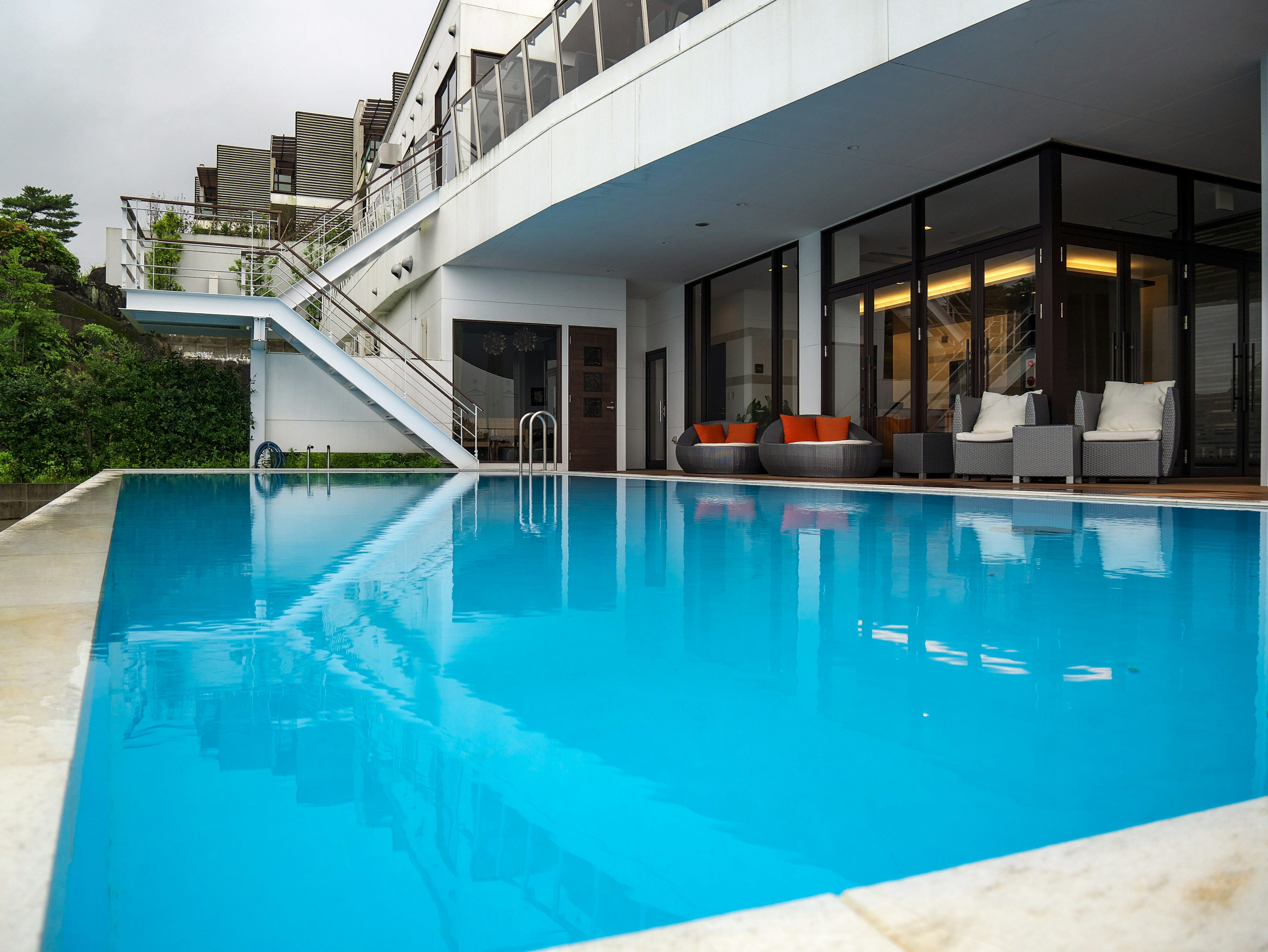 Modern resort area featuring a blue swimming pool and contemporary architecture