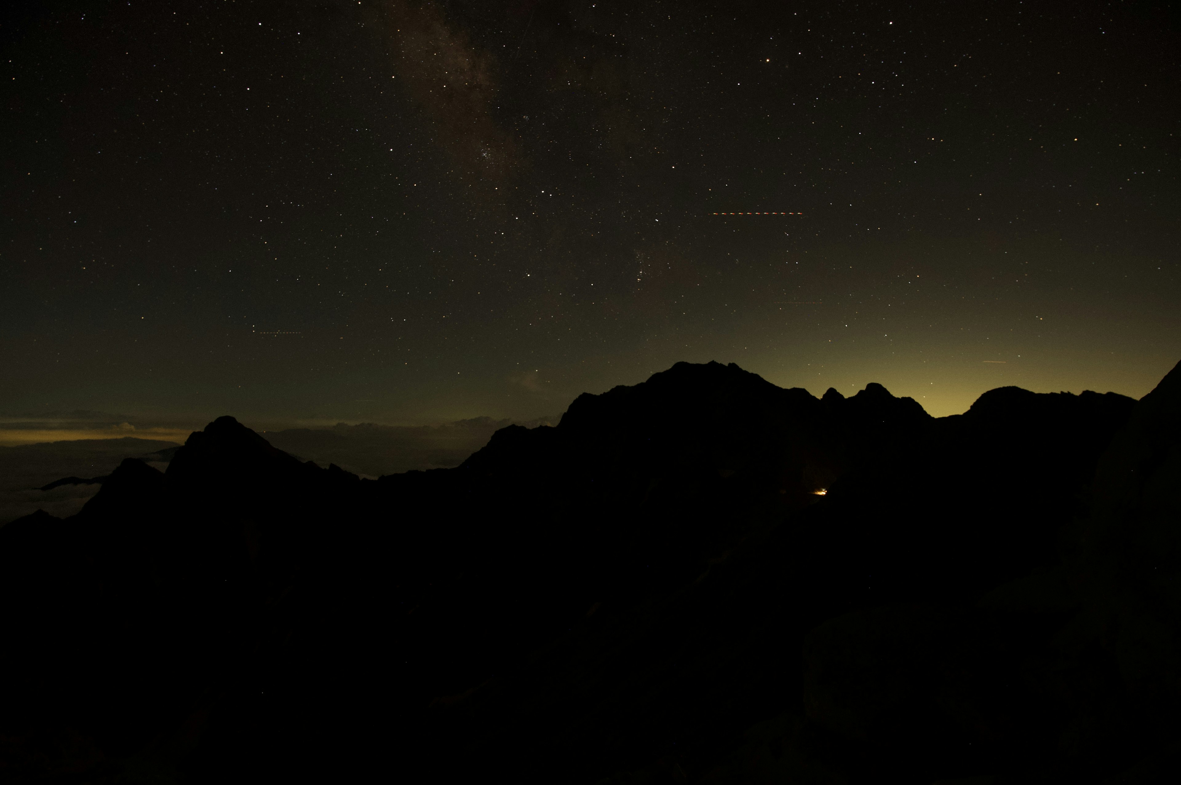 夜空に輝く星々とシルエットの山々の風景