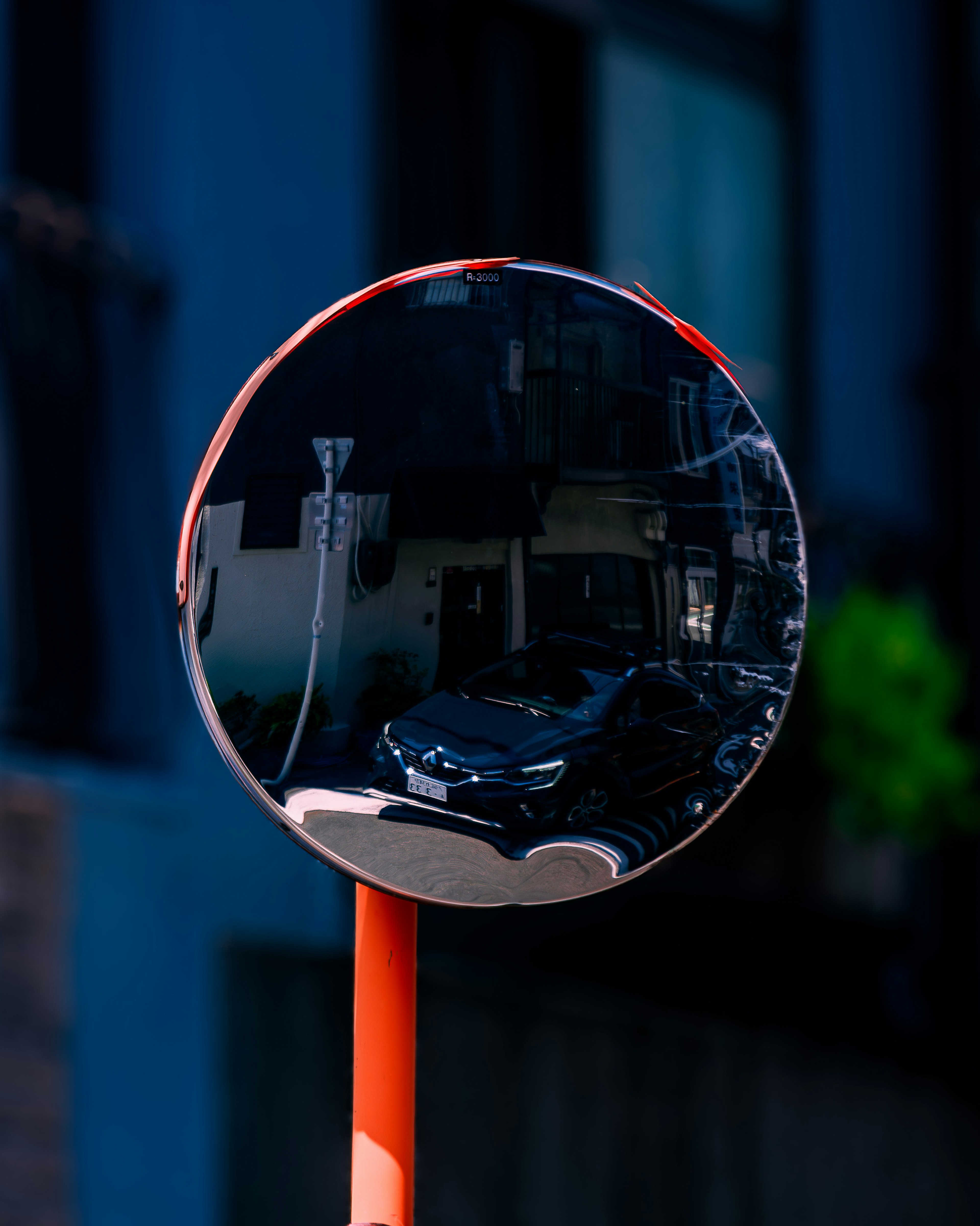 Reflective round mirror mounted on an orange pole