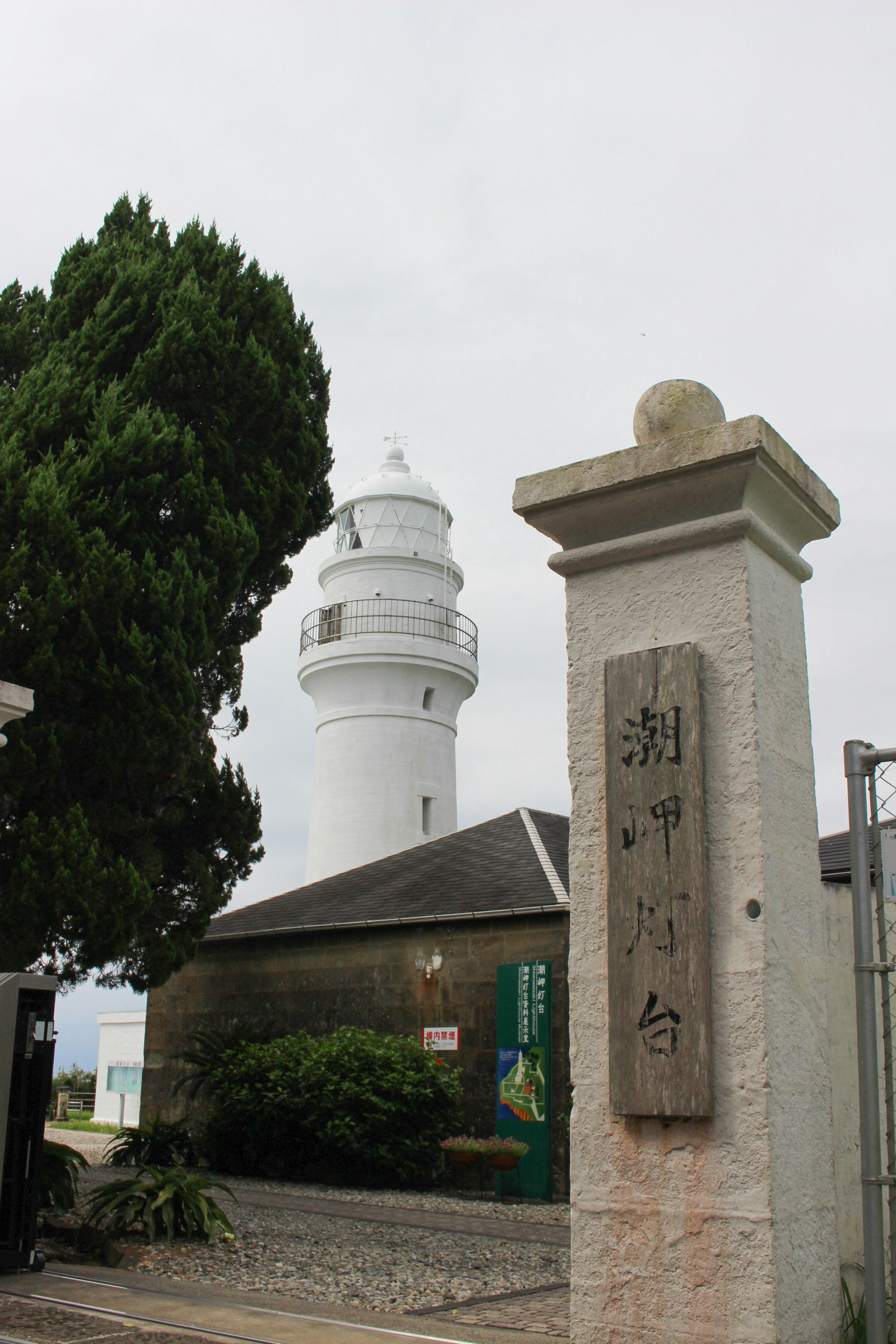 A lighthouse and a stone pillar in the landscape