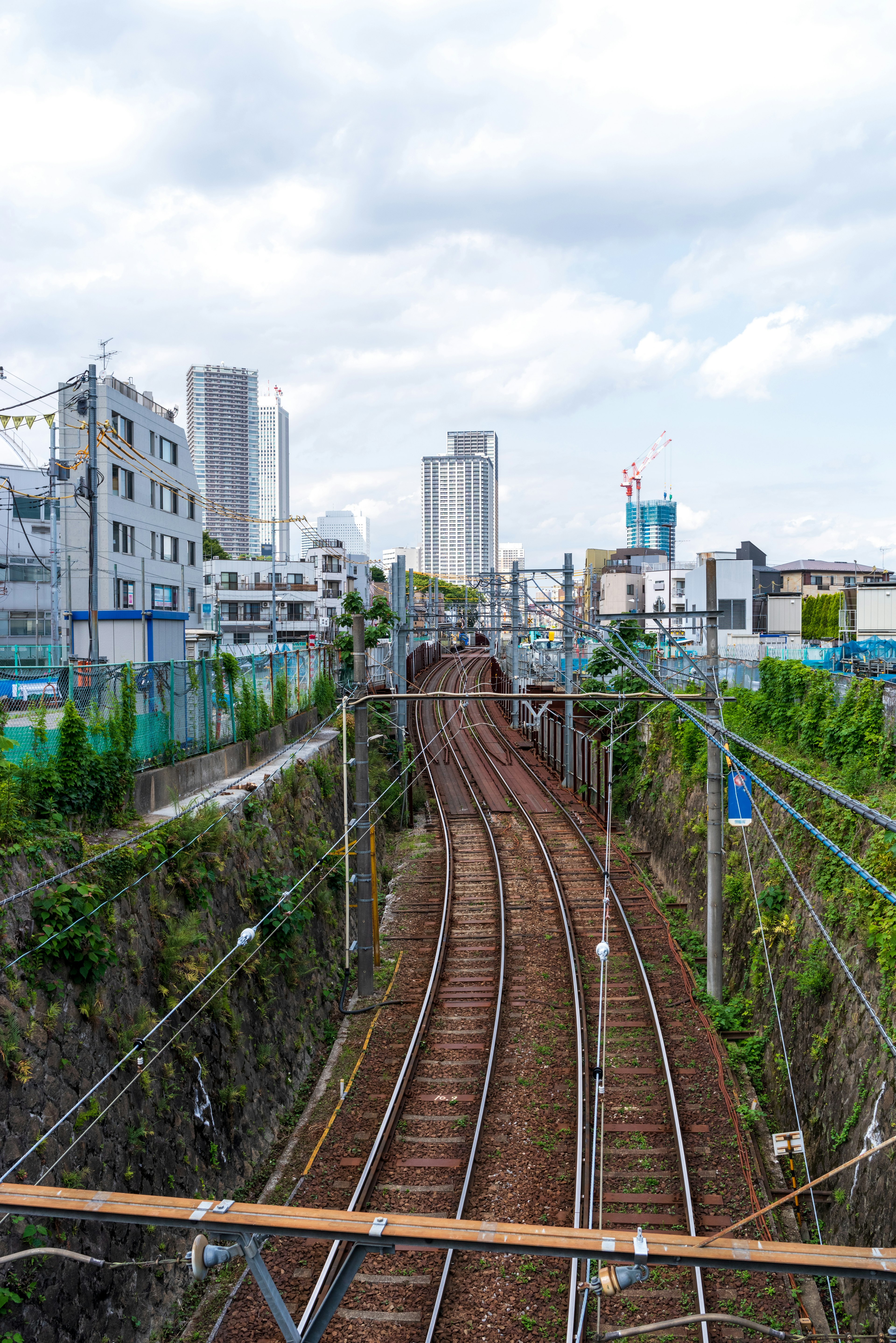 Urban railway scene curved tracks with high-rise buildings in the background