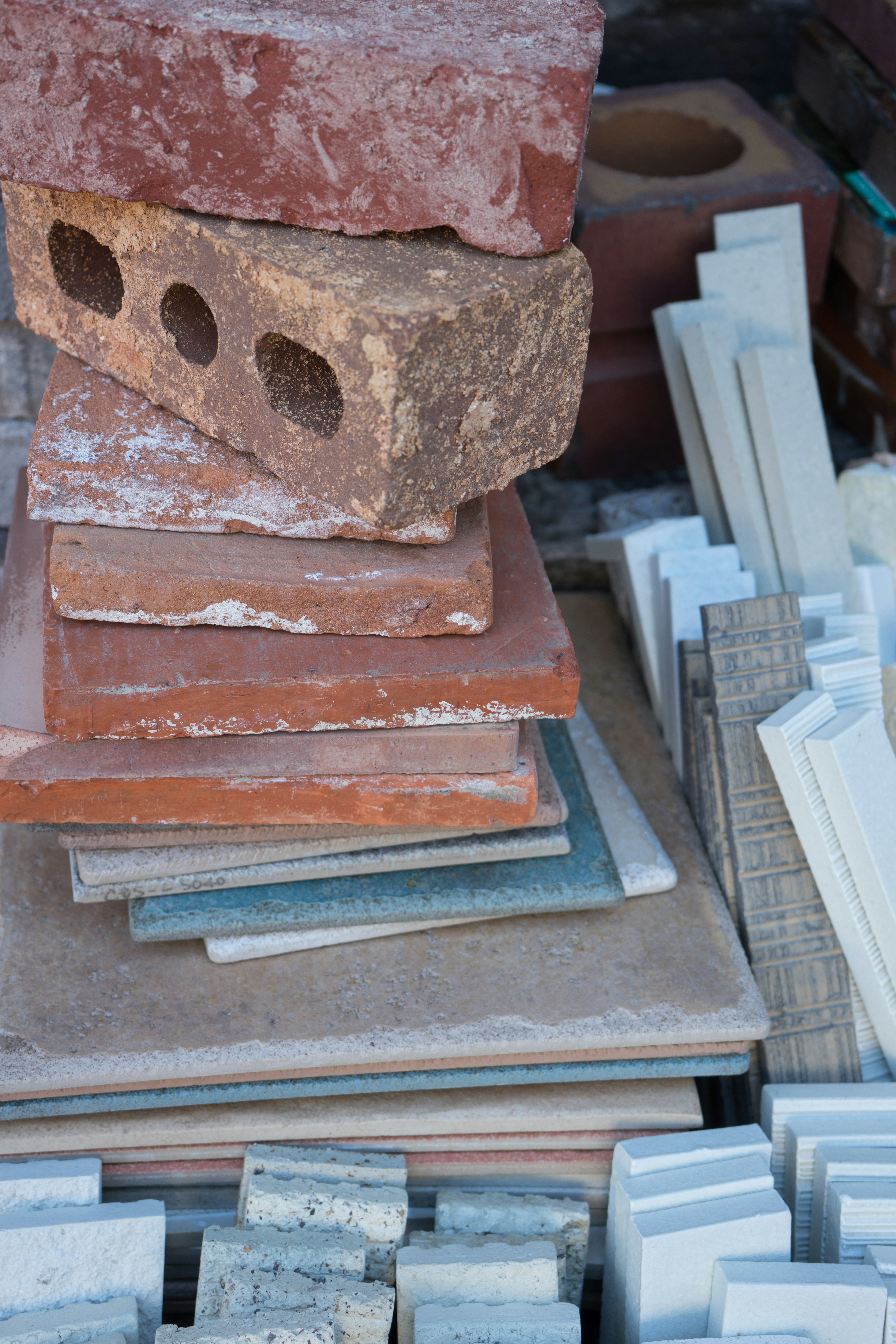 Stacked bricks and tiles in various colors and textures