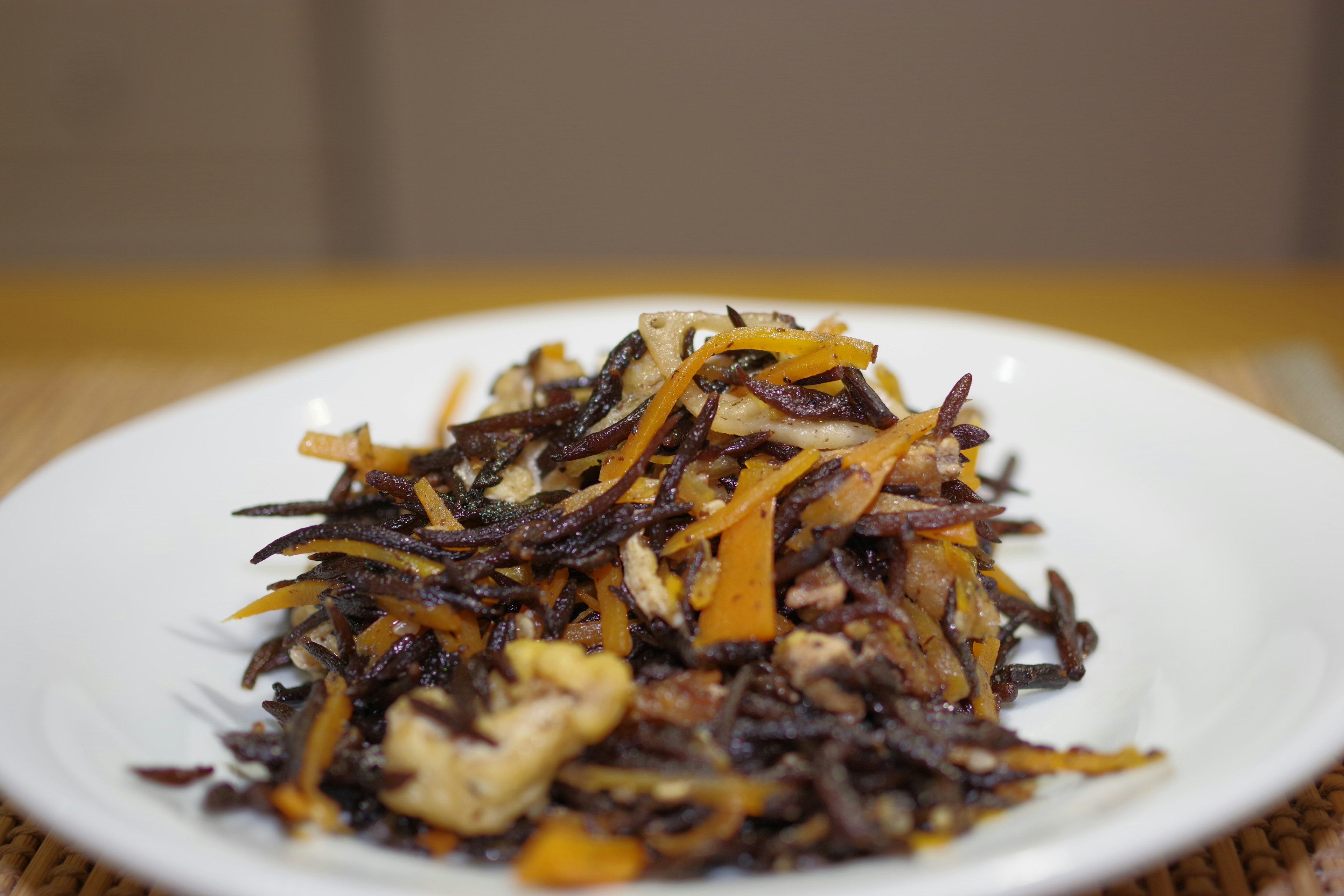 Dish featuring black sesame salad with carrots and pork