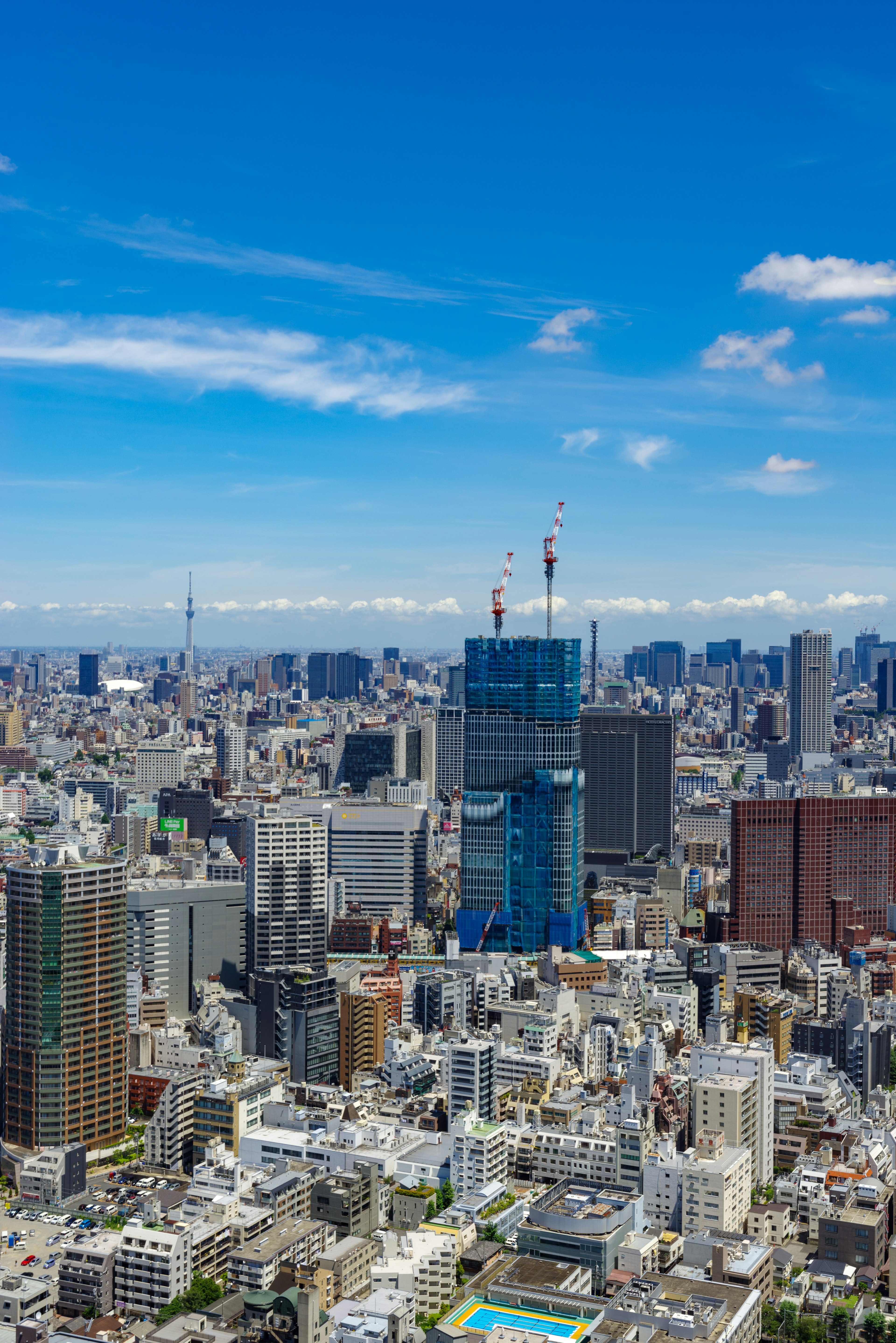 Tokyo skyline featuring high-rise buildings and a clear blue sky