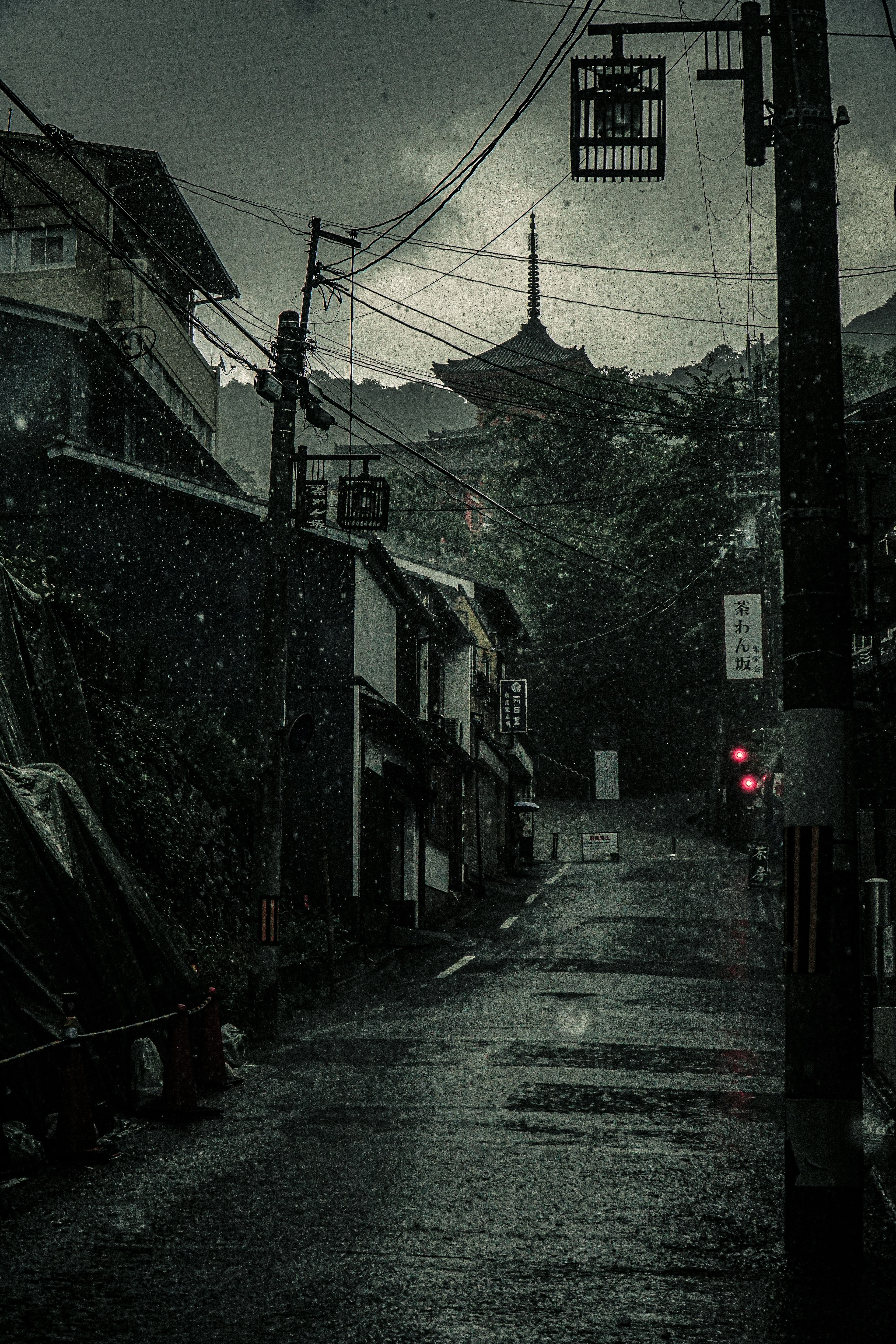 Quiet street with old buildings and mountain backdrop in rainy weather