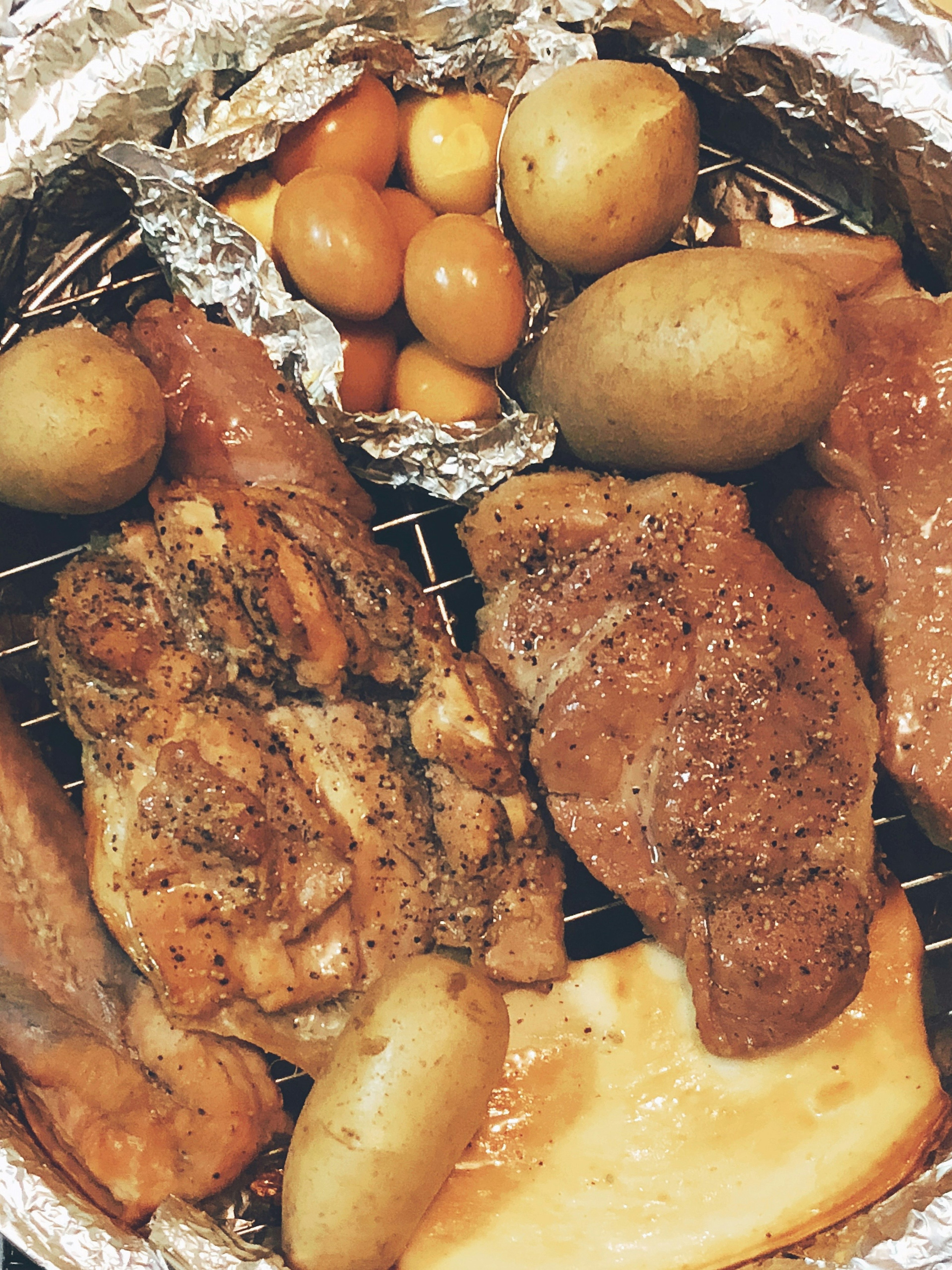 Grilled meat and potatoes arranged in a dish