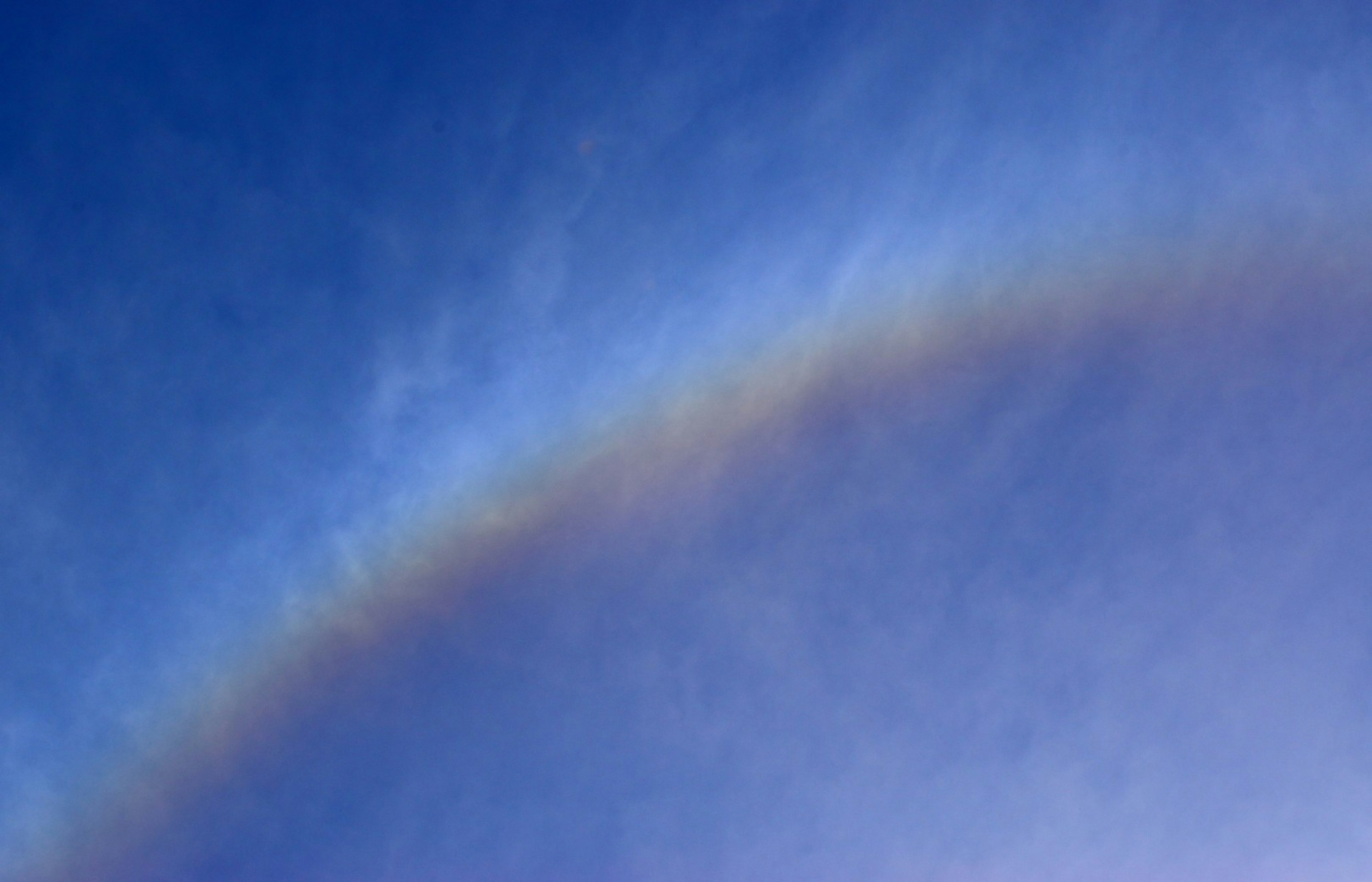 Ein sanfter Bogen aus Wolken in einem blauen Himmel